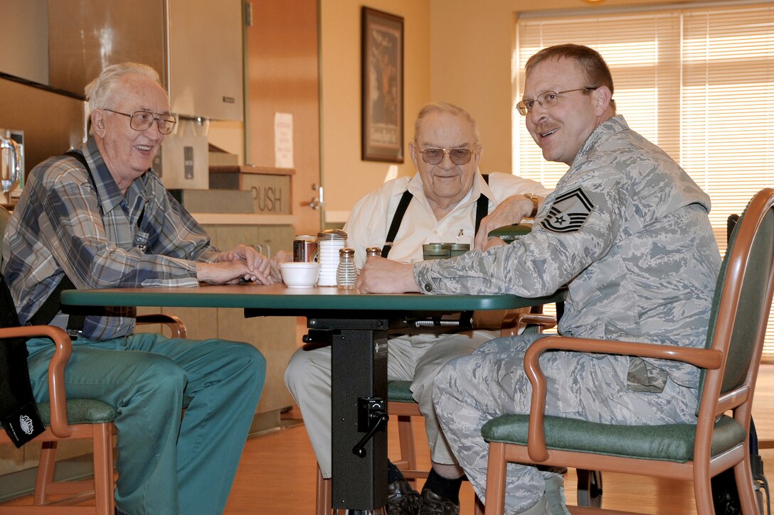 Senior Master Sgt. Tadd Goehring enjoys a chat with residents of the Eastern Nebraska Veterans Home Feb. 16, 2011, near Offutt Air Force Base, Neb. Sergeant Goehring is assigned to the 55th Aircraft Maintenance Squadron. (U.S. Air Force photo/Jeff W. Gates)