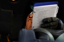 U.S. Air Force Tech. Sgt. Justin Day, Air Force Special Operations Training Center instructor loadmaster, observes a student performing a startup checklist during familiarization training on an EC-130J Feb. 7, 2011, Harrisburg International Airport, Pa. The new EC-130J model will reduce the crew complement from nine to five members. The loadmaster will be the systems expert and handle the duties traditionally performed by a flight engineer. (U.S. Air Force photo by Staff Sgt. Julianne M. Showalter/Released)