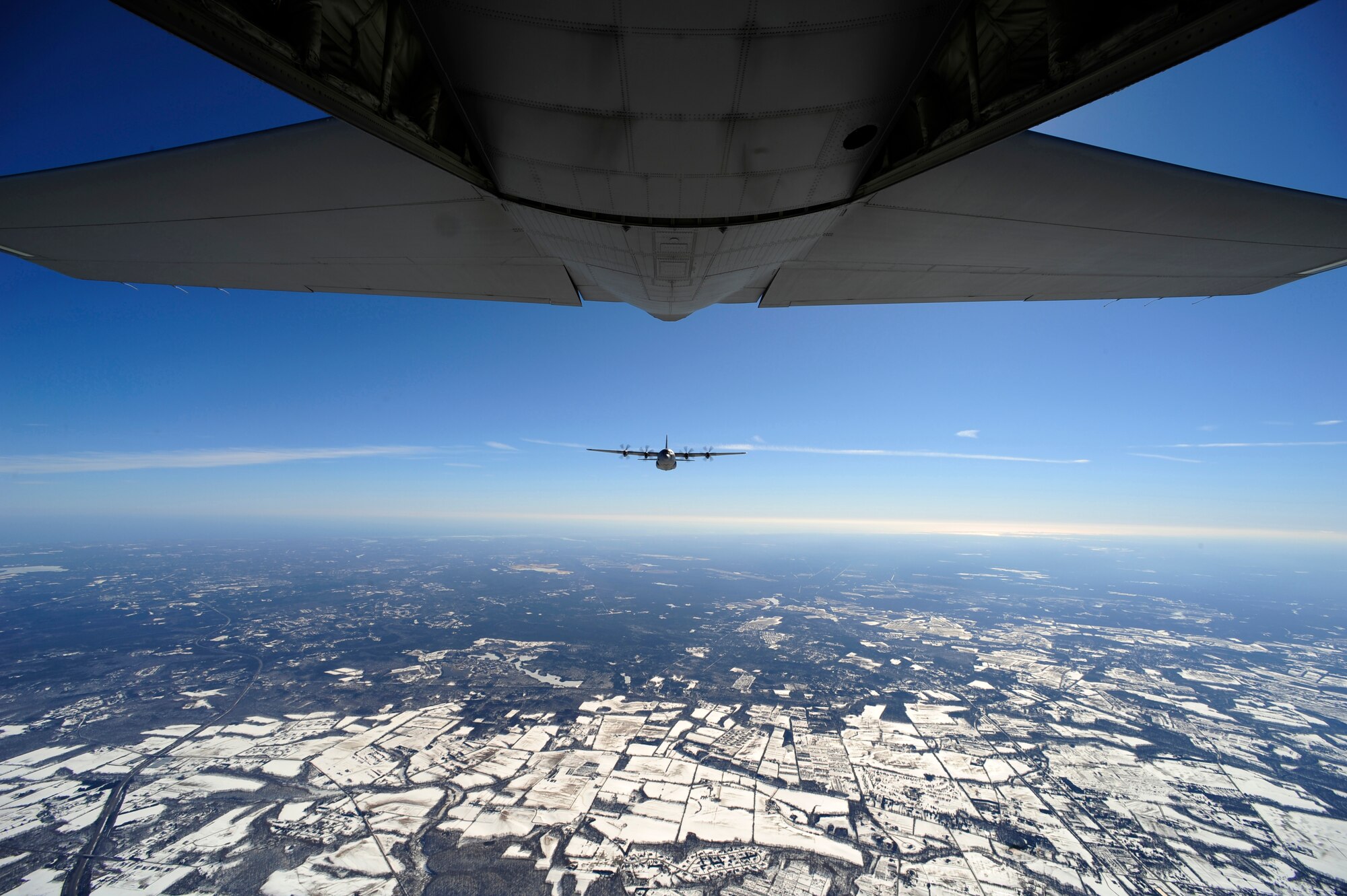 An EC-130J from the 193rd Special Operations Squadron flown by Air Force Special Operations Training Center students class 1101, flies in formation during a training sortie Feb. 11, 2011, Harrisburg, Pa. Class 1101 is the first group of students to attend mission qualification training for the EC-130J that will replace all the E- and P-model aircraft within the next few years. The EC-130 J is equipped with modern avionics, mission systems and a more capable and sustainable airframe that will provide specialized mobility to combatant commanders. (U.S. Air Force photo by Staff Sgt. Julianne M. Showalter/Released)