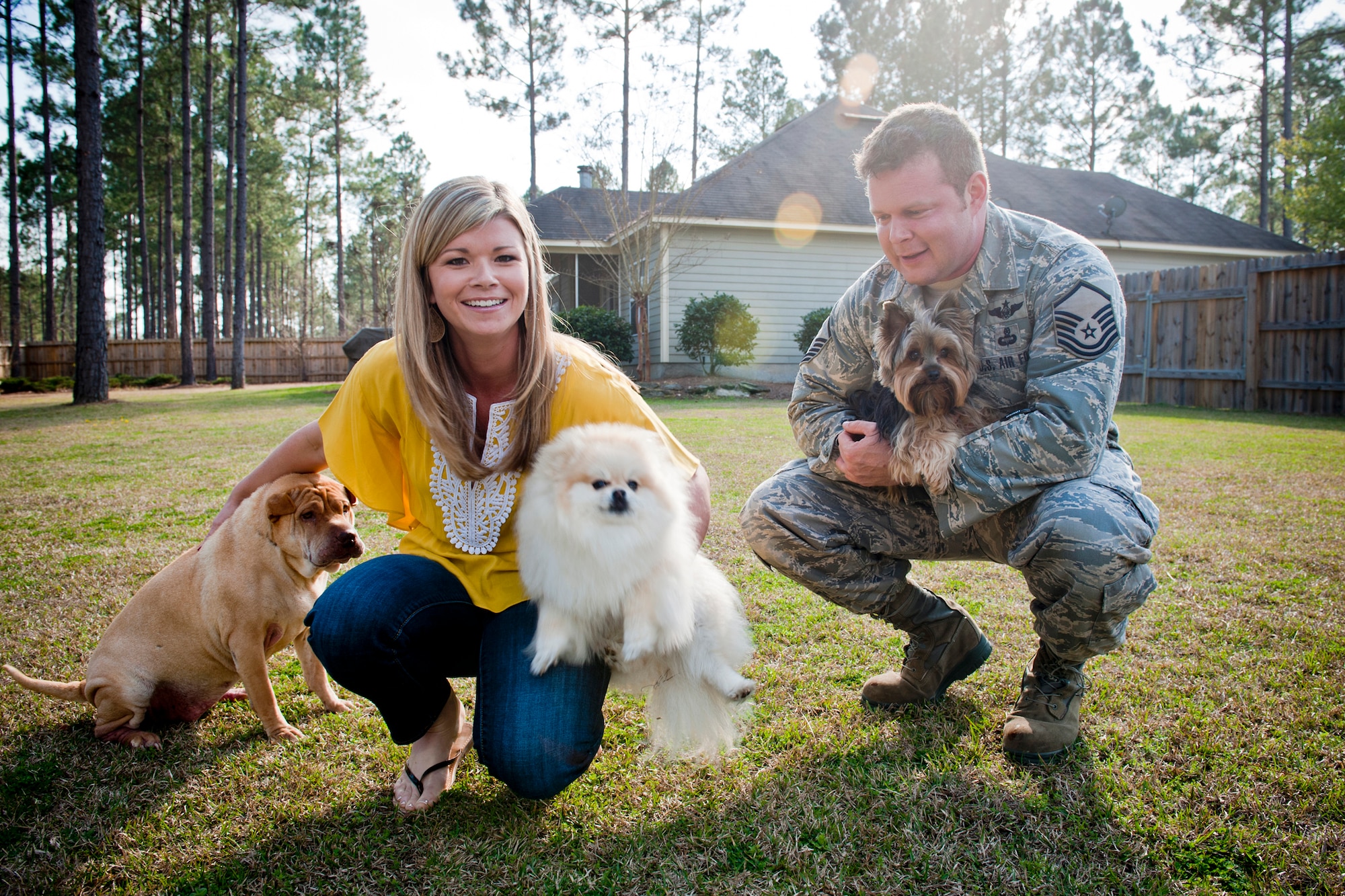 Master Sgt. Robert Disney and his wife, Tess, gather their dogs, Sasha, Minnie and Wall-E, for a photo Feb. 24, 2011, at their home. Sergeant Disney is the 347th Rescue Group standards and evaluations superintendent. (U.S. Air Force photo/Staff Sgt. Jamal D. Sutter)