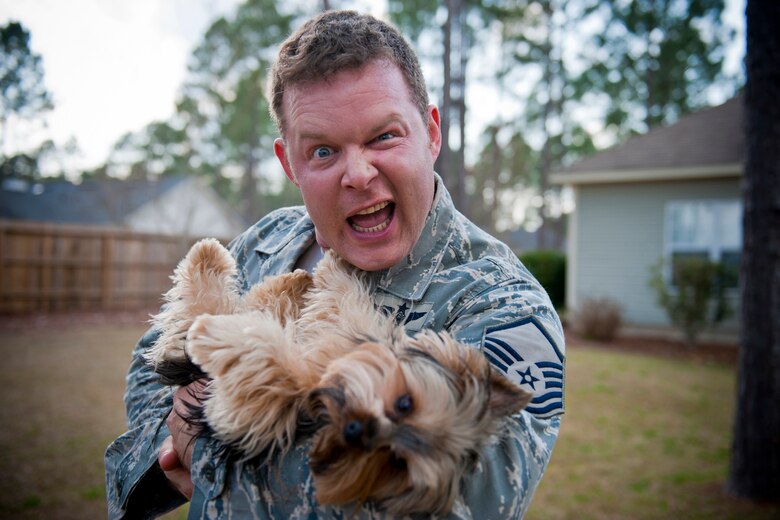 Master Sgt. Robert Disney strikes a pose with his dog, Wall-E, Feb. 24, 2011, at his home. Of his three dogs, Wall-E is his favorite because he is the only male. Sergeant Disney is the 347th Rescue Group standards and evaluations superintendent. (U.S. Air Force photo/Staff Sgt. Jamal D. Sutter)