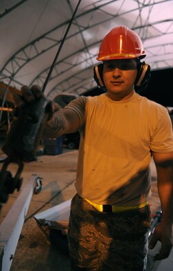 MOODY AIR FORCE BASE, Ga.-- Senior Airman Jesus Evaro, 23rd Equipment Maintenance Squadron crash recovery, uses a cobra crane as he removes large components from an A-10C Thunderbolt II during recent maintenance. Communication and successful hand-off is key for each shift to ensure steps during maintenance are not missed or duplicated. (U.S. Air Force photo/Airman 1st Class Benjamin Wiseman)(RELEASED)