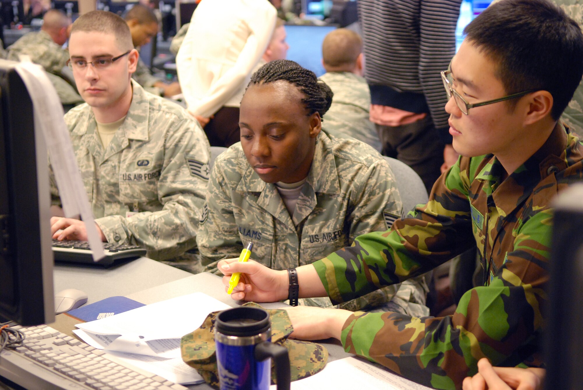 Staff Sgt. Hwang Song Hun works with Staff Sgts. Muneerah Williams and Michael Rowe to prepare for exercise Key Resolve Feb. 24, 2011, at Osan Air Base, South Korea. Sergeant Hwang is a South Korean air simulation specialist, and Sergeant Williams and Rowe are air operators assigned to Kunsan Air Base, South Korea.