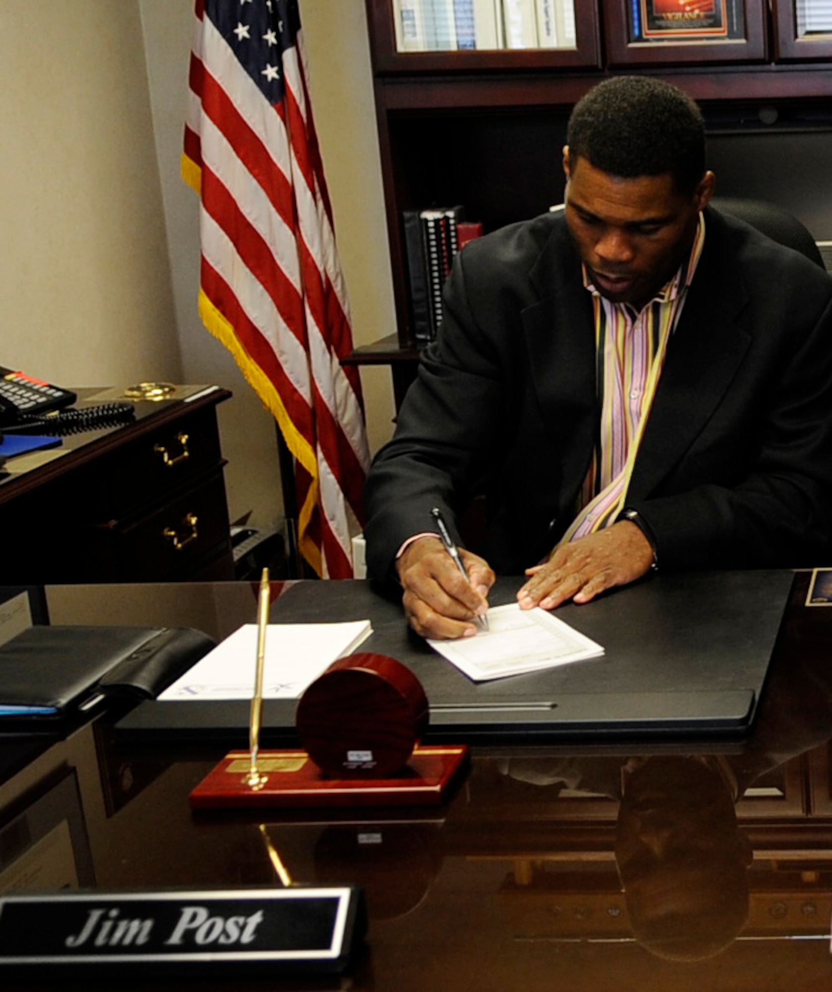 Herschel Walker signs Brig. Gen. Jim Post's calendar Feb. 24, 2011 Eielson Air Force Base, Alaska. General Post was currently TDY to Guam when Mr. Walker came to Eielson to speak to Airmen about mental illness and the benefits of seeking healthcare.  General Post is the 354th Fighter Wing commander. Mr. Walker is a former Heisman Trophy winner and NFL champion. (U.S. Air Force photo/Airman 1st Class Laura Goodgame) 