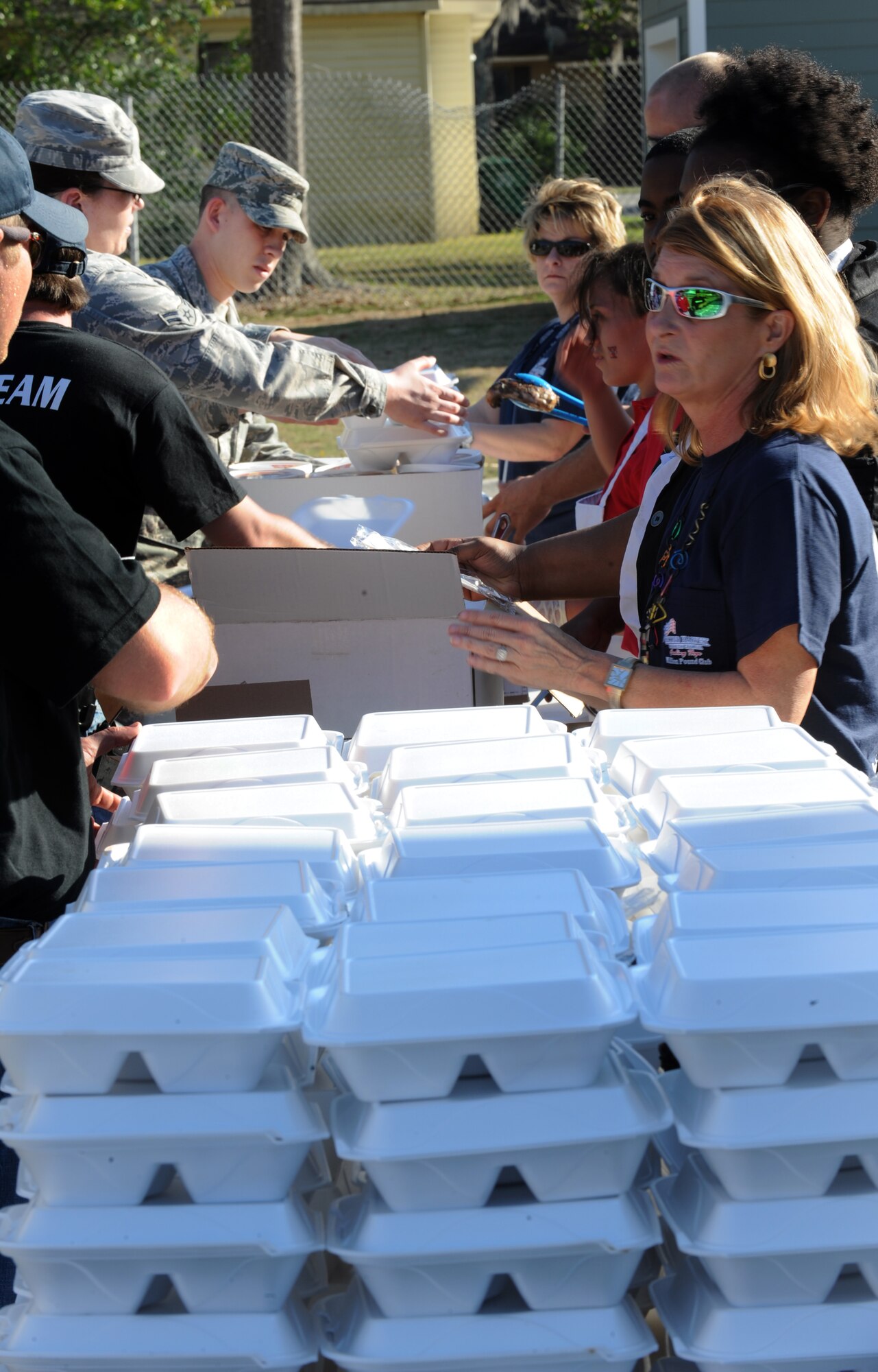 VALDOSTA, Ga. -- Volunteers assemble plastic foam containers with food to hand out to members of the Valdosta community Feb. 28. These volunteers consisted of members from Moody Air Force Base, Second Harvest of South Georgia, Students in Free Enterprise and a grill team from a local restaurant. (U.S. Air Force photo/Airman 1st Class Douglas Ellis)(RELEASED)