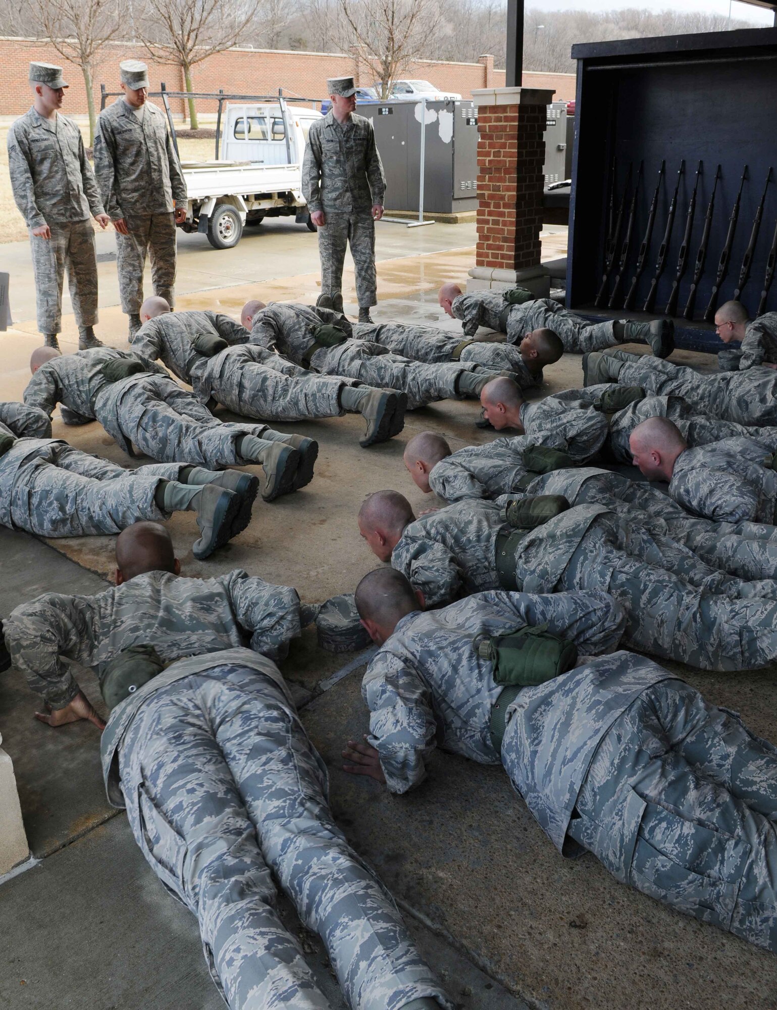 Trainees in The U.S. Air Force Honor Guard technical training school do push-ups Feb. 25 at Joint Base Anacostia-Bolling, Washington, D.C. The USAF Honor Guard trainees are required to give 100% daily while in training. (U.S. Air Force photo by Senior Airman Christopher Ruano)