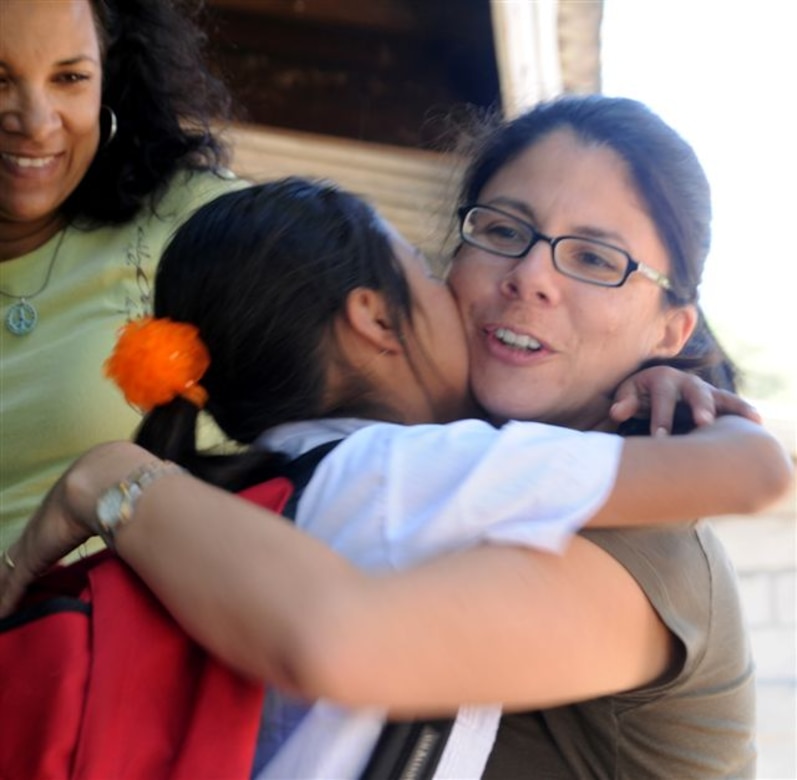 SOTO CANO AIR BASE, Honduras - After receiving a backpack filled with school supplies, an overwhelmed student kisses and hugs Rosanna Kingston, Give a Kid a Backpack founder and president. Joint Task Force-Bravo assisted in delivering backpacks to more than 700 Honduran children Feb. 23 and 24. (U.S. Air Force photo/Staff Sgt. Kimberly Rae Moore)