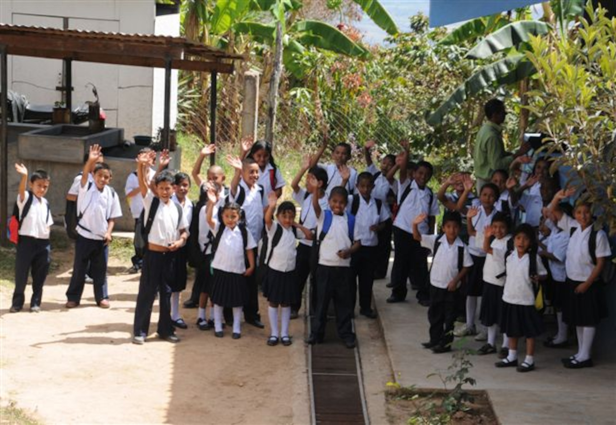 SOTO CANO AIR BASE, Honduras - Playoncito, Ajuterique students wave goodbye after receiving donations of backpacks filled with school supplies from Give a Kid a Backpack. Joint Task Force-Bravo assisted in delivering backpacks to more than 700 Honduran children Feb. 23 and 24. (U.S. Air Force photo/Staff Sgt. Kimberly Rae Moore)