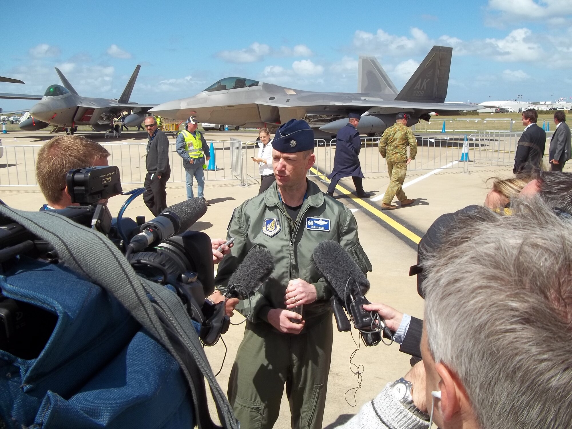 Lt. Col. Christopher Niemi, an F-22 pilot from the 525th Expeditionary Fighter Squadron, at Joint Base Elmendorf-Richardson, Alaska, speaks to media about the F-22 Raptor immediately following the opening ceremony of the Avalon 2011 Australia International Airshow and Aerospace and Defence Exposition in Geelong, Australia, on March 1, 2011. (U.S. Air Force photo/ Lt. Col. Kenneth Hoffman)