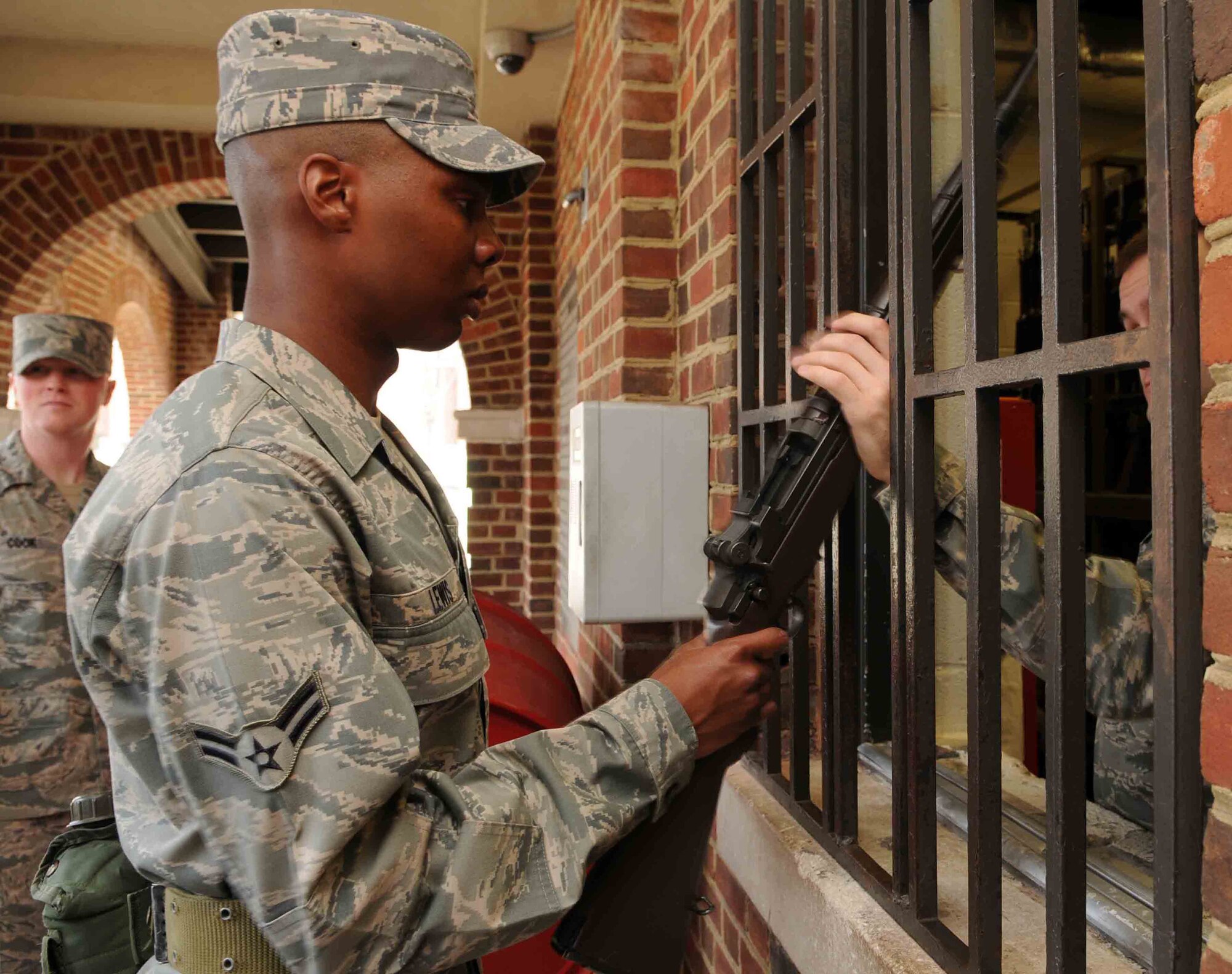 Airman 1st Class Adaultha Lewis, a trainee in The U.S. Air Force Honor Guard, picks up his training rifle from the armory Feb. 25 at Joint Base Anacostia-Bolling, Washington, D.C. The new trainees are issued the rifle to begin practicing drills during week two of technical training to become a Honor Guard member. (U.S. Air Force photo by Senior Airman Christopher Ruano)