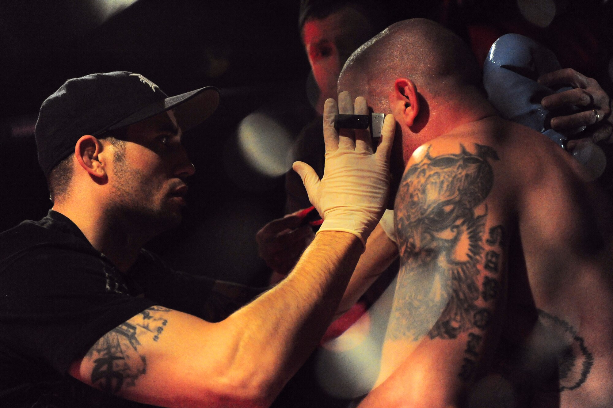 COLUMBIA, S.C. - Staff Sgt. Derrick Kennington, 20th Civil Engineer Squadron electrical power production, cleans up Staff Sgt. Ferdinando Acerra between rounds at the Caged Chaos mixed martial arts competition at Jamil Temple here Feb. 26, 2011. Sergeant Acerra is an F-16 crew chief maintenance instructor for the 20th Maintenance Operations Squadron out of Shaw Air Force Base, S.C. (U.S. Air Force photo/Airman 1st Class Daniel Phelps (Released))