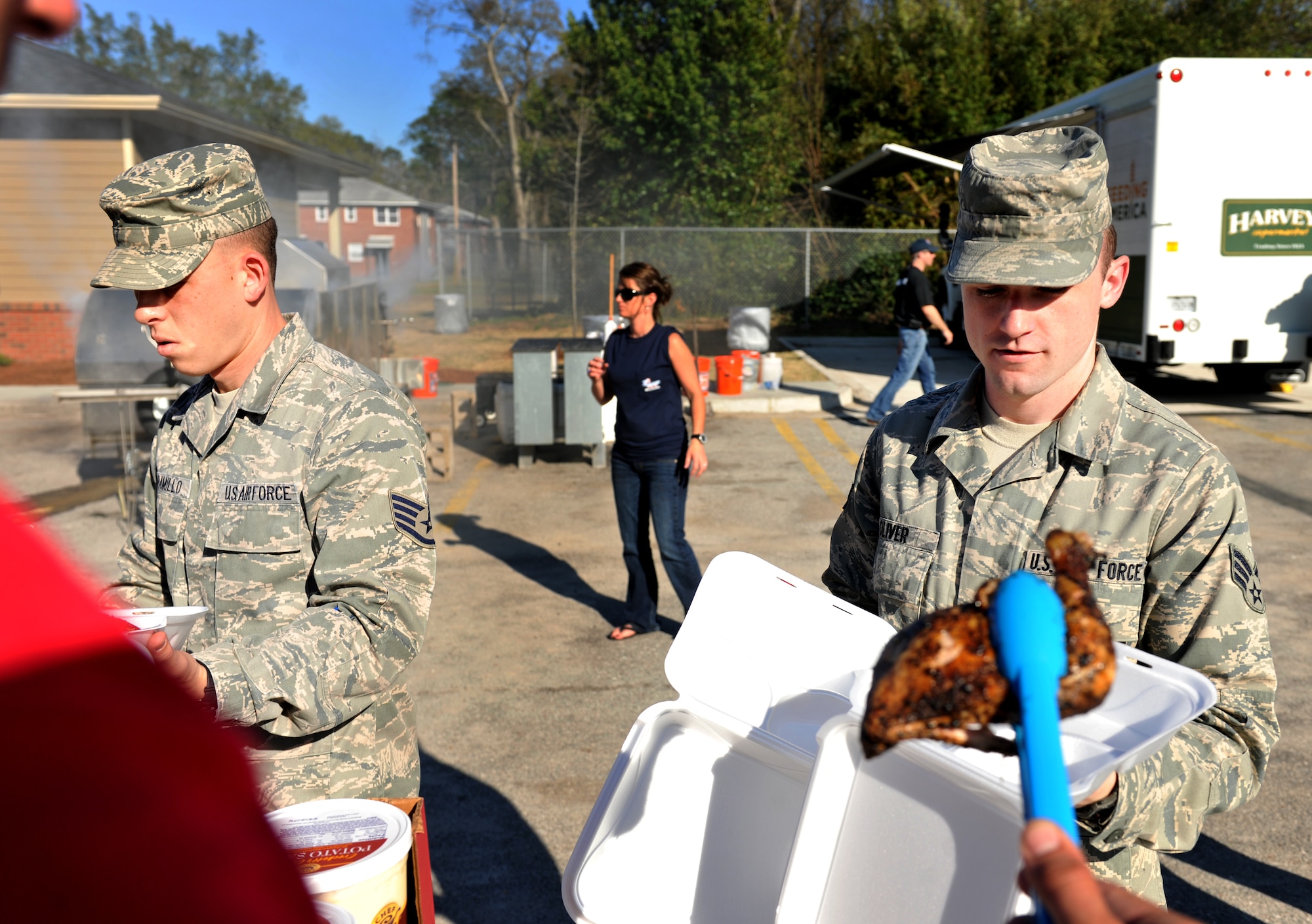VALDOSTA, Ga.-- Senior Airman Joseph Oliver, 41st Rescue Squadron intelligence analyst and Staff Sgt. Andres Jaramillo, 347th Rescue Group intelligence analyst, help fill 400 plates with food during a cookout held for the local community at a ribbon cutting ceremony for the new Skills Success Center in downtown Valdosta Feb. 28. The Airmen from Moody set a record number at Second Harvest of South Georgia for packaging 400 boxes of food in three hours and showed up to the event to show their support for the local community. (U.S. Air Force photo/Airman 1st Class Joshua Green)(RELEASED)
