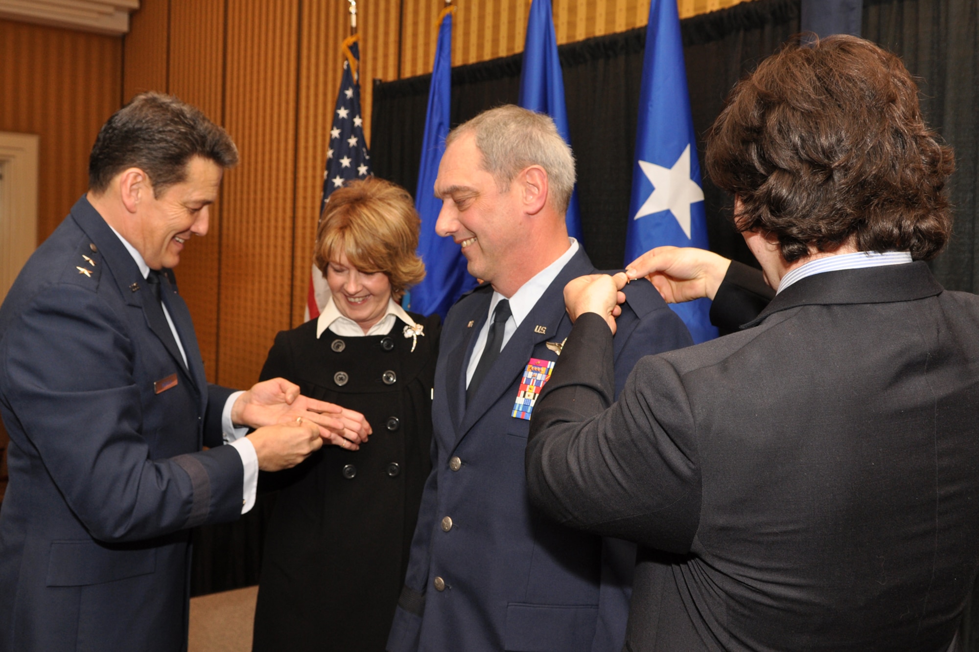 Maj. Gen. Frank Padilla, commander, 10th Air Force, hands a star to Nina Mooney as her son Patrick pins a general's rank insignia on an epaulet of his father, Brig. Gen. John J. Mooney III, during the pinning-on ceremony at the Eldorado Hotel in Shreveport, La., Feb. 25, 2010. General Mooney is the commander of the 307th Bomb Wing at Barksdale Air Force Base, La. General Padilla was the presiding official for the ceremony. Approximately 70 family members and friends were in attendance, some traveling in from as far away as Maine for the event. (Photo by Jeff Walston)  