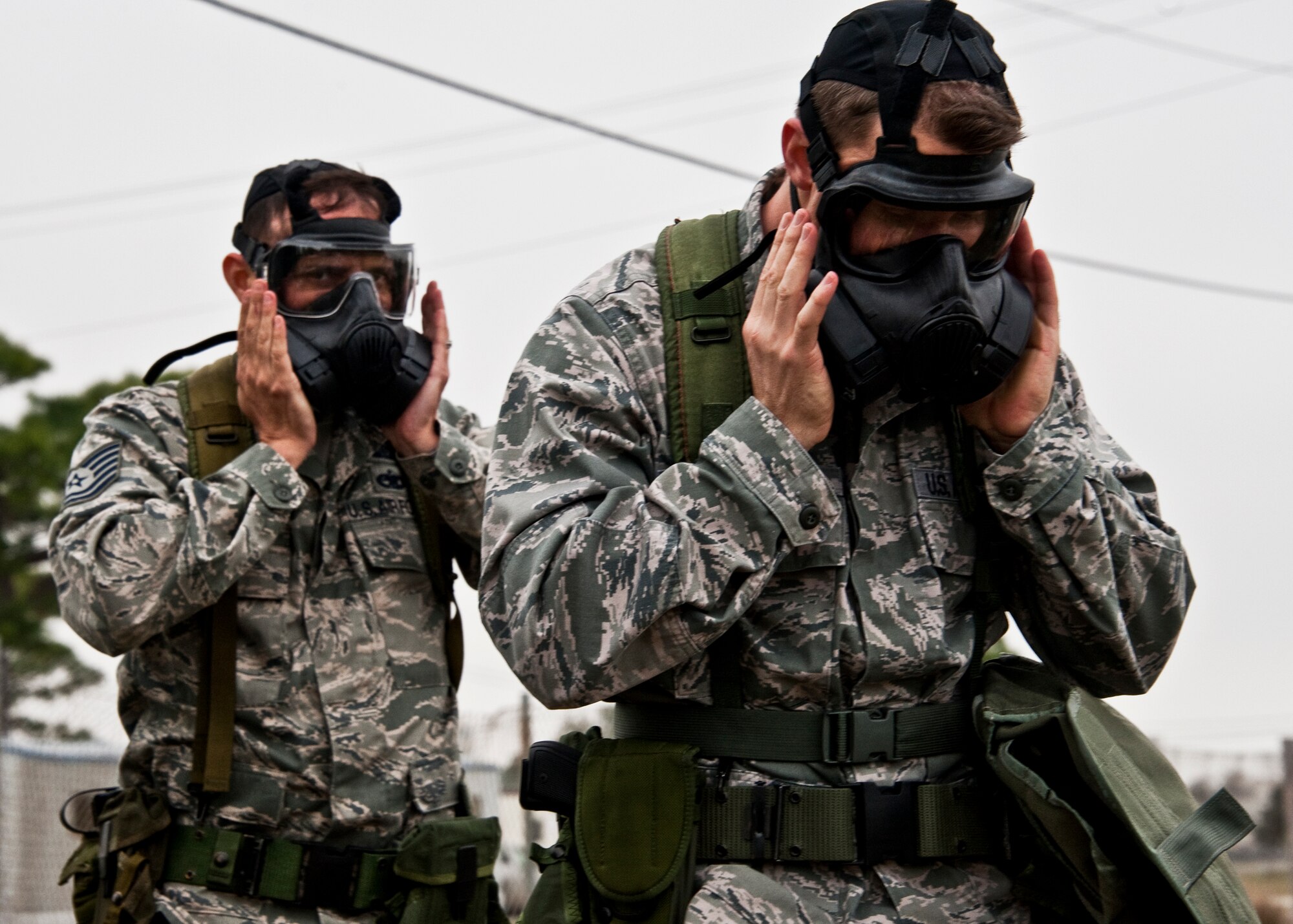 Airmen check to ensure their masks are properly sealed Feb. 24, 2011, during an operational readiness exercise at Eglin Air Force Base, Fla. (U.S. Air Force photo/Samuel King Jr.)