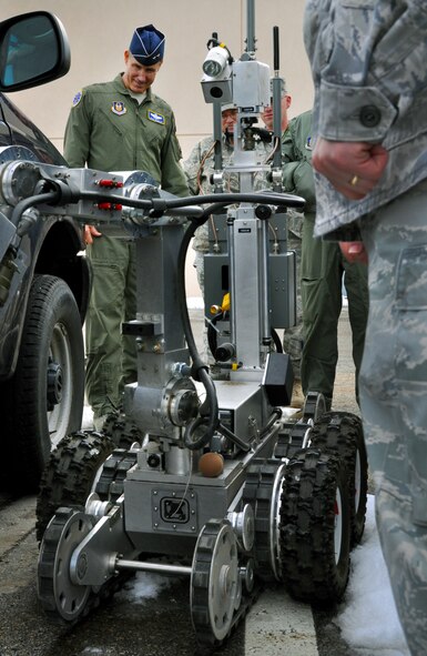 Air Force Reserve Command’s vice commander, Maj. Gen. Craig Gourley, watches an explosive ordnance disposal robot demonstration, while Staff Sgt. Jayson Johnson, an active duty Airman, controls it from yards away. Sergeant Johnson grasped the suspicious package with the machine’s claw and safely removed the item from a distance. (U.S. Air Force photo/Airman Crystal Charriere)
