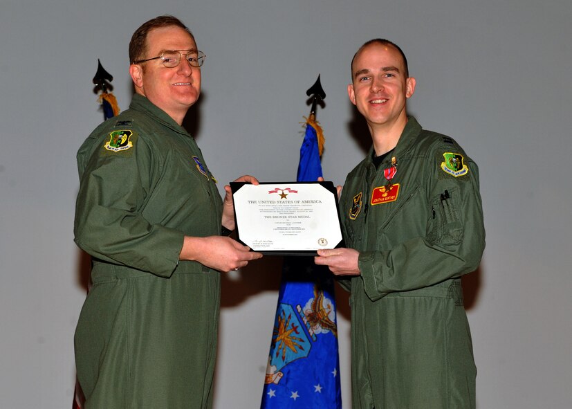 MINOT AIR FORCE BASE, N.D. -- Col. Doug Cox, 5th Bomb Wing commander, awarded Capt. Jonathan A. Gunther, 23rd Bomb Squadron B-52H Stratofortress aircraft commander, with the Bronze Star Medal for his meritorious service during Operation Enduring Freedom, at the 5th Operations Group commander's call here Feb. 25. (U.S. Air Force photo/Staff Sgt. Keith Ballard)
