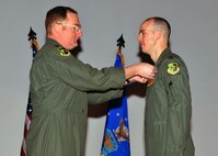 MINOT AIR FORCE BASE, N.D. -- Col. Doug Cox, 5th Bomb Wing commander, awarded Capt. Jonathan A. Gunther, 23rd Bomb Squadron B-52H Stratofortress aircraft commander, with the Bronze Star Medal for his meritorious service during Operation Enduring Freedom, at a commander's call here Feb. 25. 