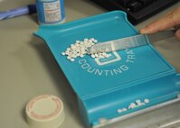 MINOT AIR FORCE BASE, N.D. -- Medication is being counted by hand inside the pharmacy at the 5th Medical Group Clinic, here Jan. 24. This is but one aspect of an office that places emphasis on the quality of care given to patients, not the quantity of patients seen in a day. (U.S. Air Force photo/Staff Sgt. Keith Ballard)
