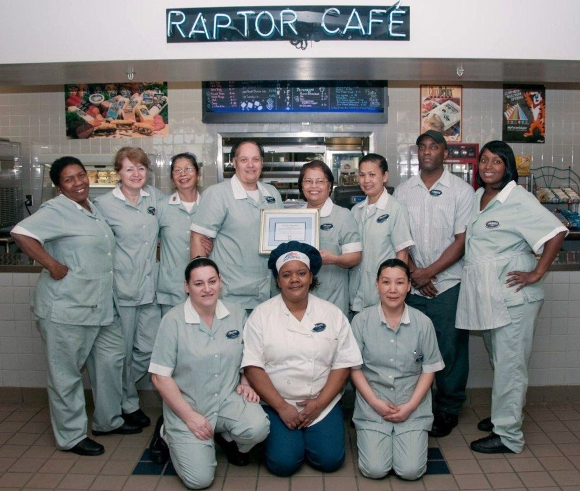 Raptor Cafe food service employees display their certificate of recognition, earned for achieving the facility's fifth consecutive "Excellent" public health rating Feb. 17 at Langley Air Force Base, Va. The award marks the first time the current company earned the honor. Each employee received a $50 gift card for their accomplishments. (Courtesy photo)