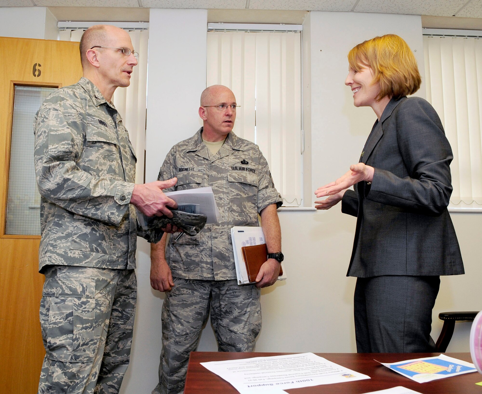 RAF MILDENHALL, England -- Jennifer Johnson, 100th Force Support Squadron Airman and Family Readiness Center community readiness consultant, tells Col. James Miner and Chief Master Sgt. Kyle Robinette, members of an evaluation team here Feb. 25, 2011, about services offered by the A&FRC as part of an evaluation for the Maj. Gen. Eugene L. Eubank Services Award. The 100th Force Support Squadron is the first of four finalists for the Eubank's award to be evaluated for the final decision on the winner. (U.S. Air Force photo/Senior Airman Ethan Morgan)