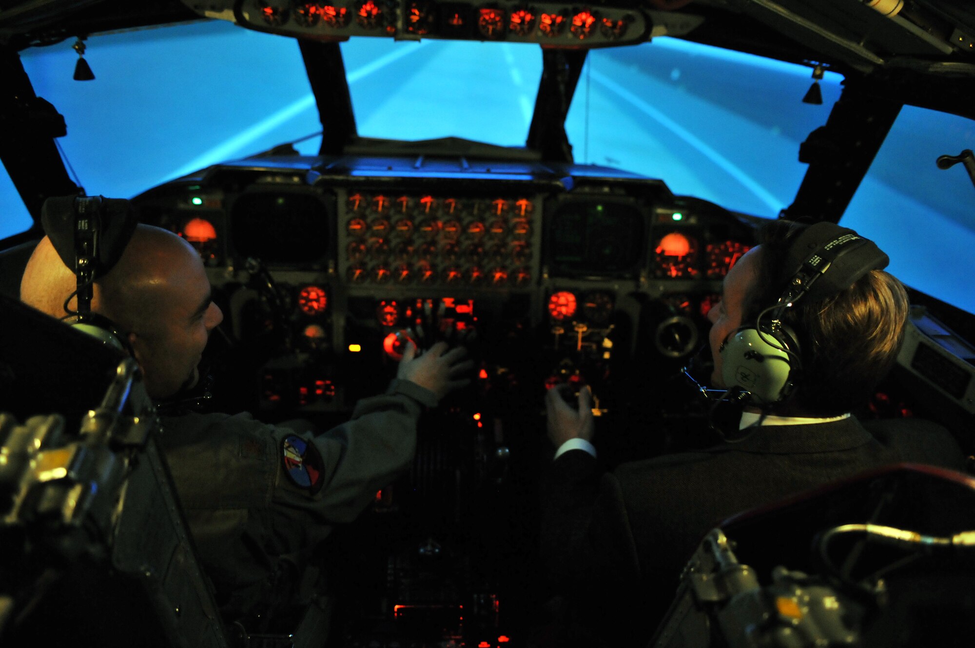 MINOT AIR FORCE BASE, N.D. -- N.D. Congressman Rick Berg lands a B-52H Stratofortress with Maj. Robustino Rodriguez, 23rd Bomb Squadron director of operations, inside the B-52 simulator here Feb. 23. This trip marked the Congressman’s first visit to Minot to familiarize himself with the base and its mission.  (U.S. Air Force photo/Staff Sgt. Keith Ballard)