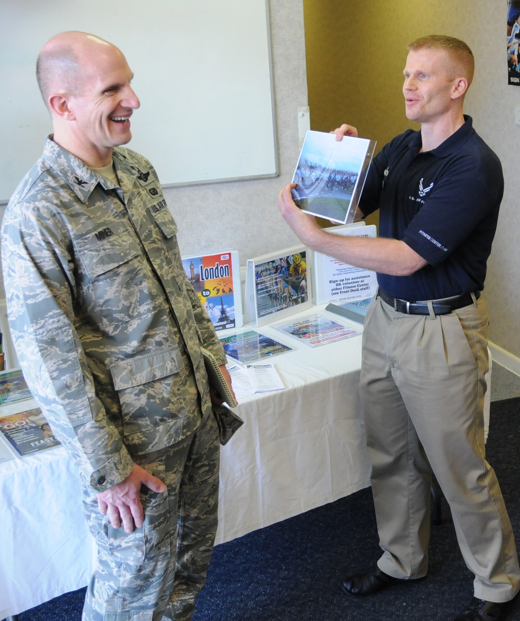 RAF MILDENHALL, England -- Col. James Miner, Maj. Gen. Eugene L. Eubank Services Award evaluation team, listens to Staff Sgt. Zachary Rule, 100th Force Support Squadron, tell how the dependent of a base group commander wins a majority of the base 5K fun runs Feb. 25, 2011. Evaluators visited 100th FSS facilities as the squadron is one of four finalists for the Air Force-level award that highlights the best force support squadron operation. (U.S. Air Force photo/Staff Sgt. Thomas Trower)