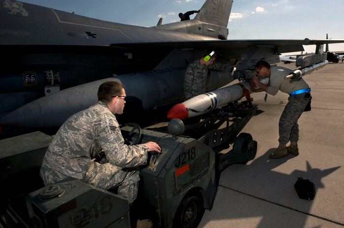 NELLIS AIR FORCE BASE, Nev. -- Senior Airman Houston Dewitt, Airman 1st Class John Grasso, and Staff Sgt. Andre Johnson, 20th Aircraft Maintenance Squadron armament systems craftsmans, Shaw Air Force Base, S.C., prepare to unload a AGM-88A Air-to-Ground missile off of a F-16 Fighting Falcon during Red Flag 11-3,  Feb. 24.  Red Flag is a realistic combat training exercise involving the air forces of the United States and its allies. The exercise is hosted north of Las Vegas on the Nevada Test and Training Range. (U.S. Air Force photo by Senior Airman Brett Clashman)