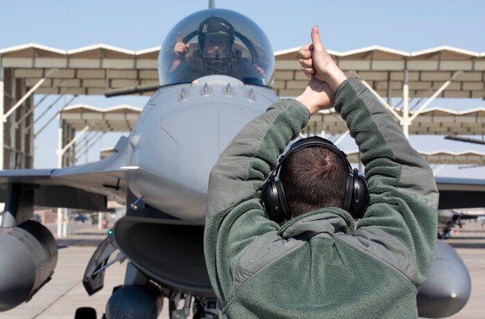 NELLIS AIR FORCE BASE, Nev. -- Senior Airman Jason Carey, 20th Aircraft Maintenance Squadron crew chief, Shaw Air Force Base, S.C. gives a thumbs up to Capt. William Weston, 20th Fighter Wing F-16 Fighting Falcon pilot during Red Flag 11-3, Feb. 24.  Red Flag is a realistic combat training exercise involving the air forces of the United States and its allies. The exercise is hosted north of Las Vegas on the Nevada Test and Training Range. (U.S. Air Force photo by Senior Airman Brett Clashman)