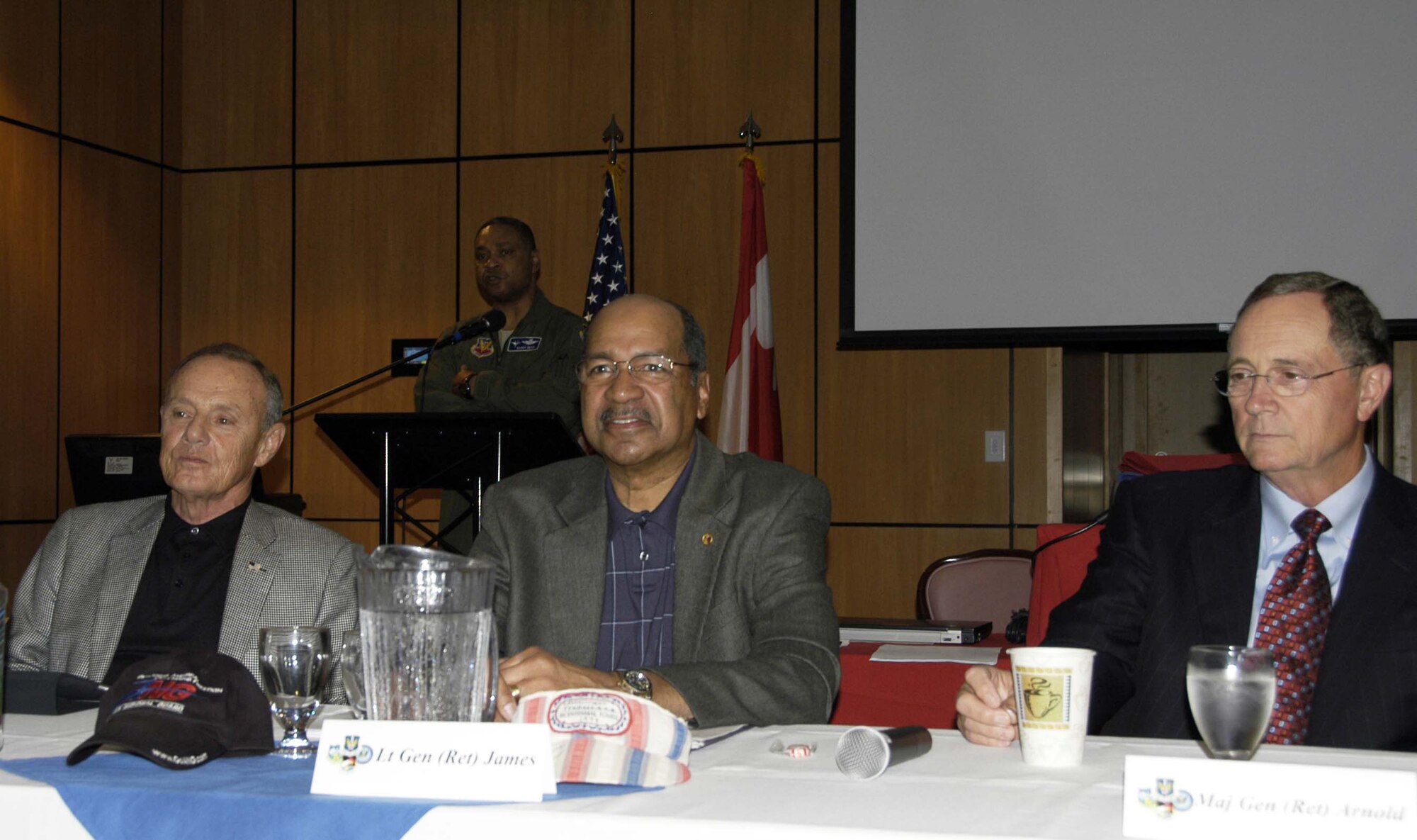 Maj. Gen. Garry C. Dean (background), Continental U.S. North American Aerospace Defense Command Region-1st Air Force and Air Forces Northern commander, introduces the members of the Senior Statesmen Panel during the 1st AF Commander’s Conference at the Horizons Community Center at Tyndall Air Force Base, Fla., Feb. 24. The panel featured (left to right) Maj. Gen. (retired) Philip Killey, former 1st AF commander and namesake of the Killey Center for Homeland Operations where 1st AF is housed; Lt. Gen. (retired) Daniel James III, former director of the Air National Guard; and Maj. Gen. (retired) Larry Arnold, 1st AF commander on Sept. 11, 2001. (U.S. Air Force photo by Angela Pope)