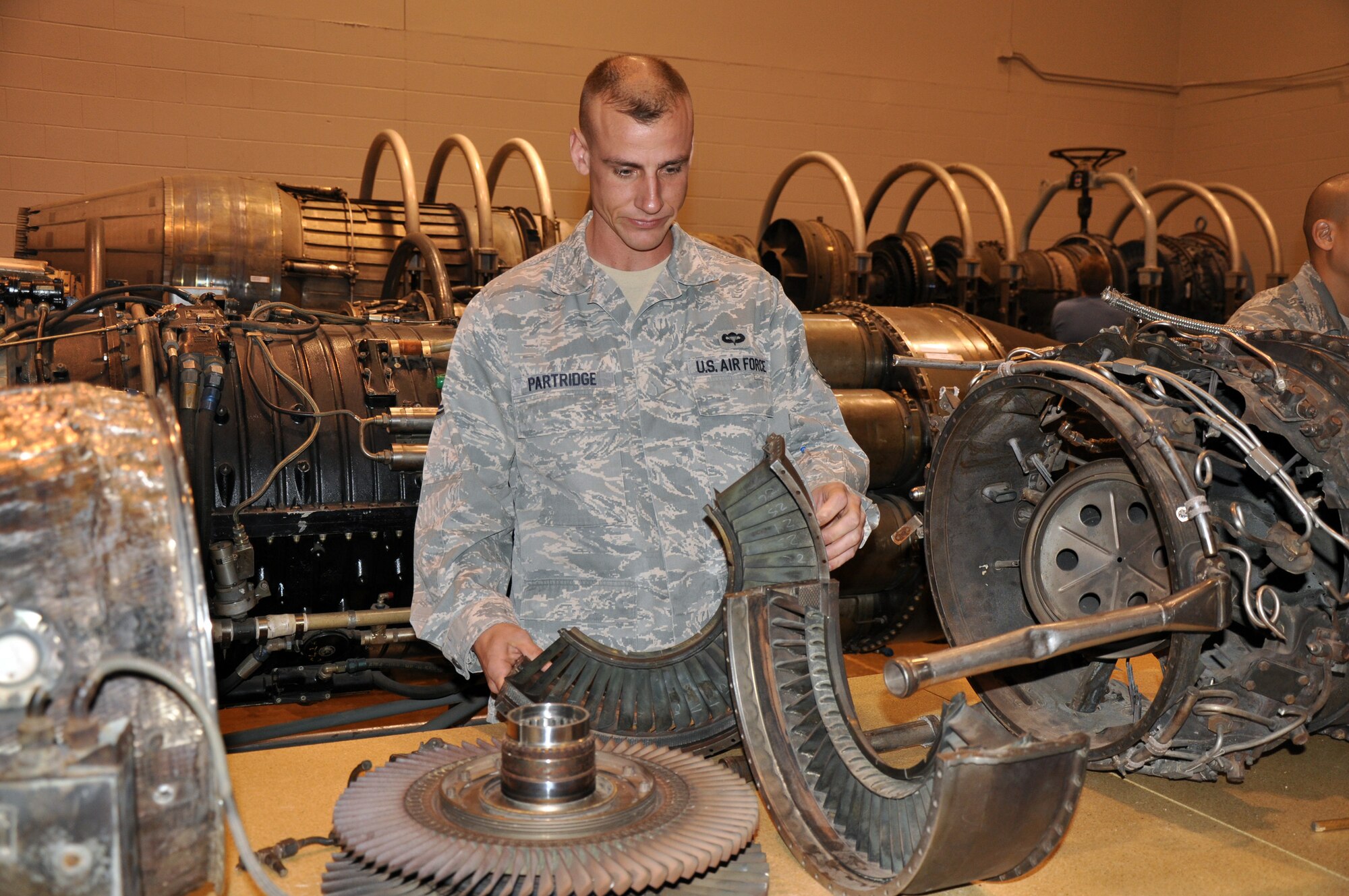 Tech. Sgt. Jason Partridge, 317th Maintnenance Operations Squadron quality assurance inspector at Dyess Air Force Base, Texas, inspect jet engine parts at the 361st Training Squadron's Jet Engine Mishap Investigation Course. Students go through the nine-day course to learn how to investigate and determine the cause of a catastrophic engine failure. (U.S. Air Force photo/John Ingle)