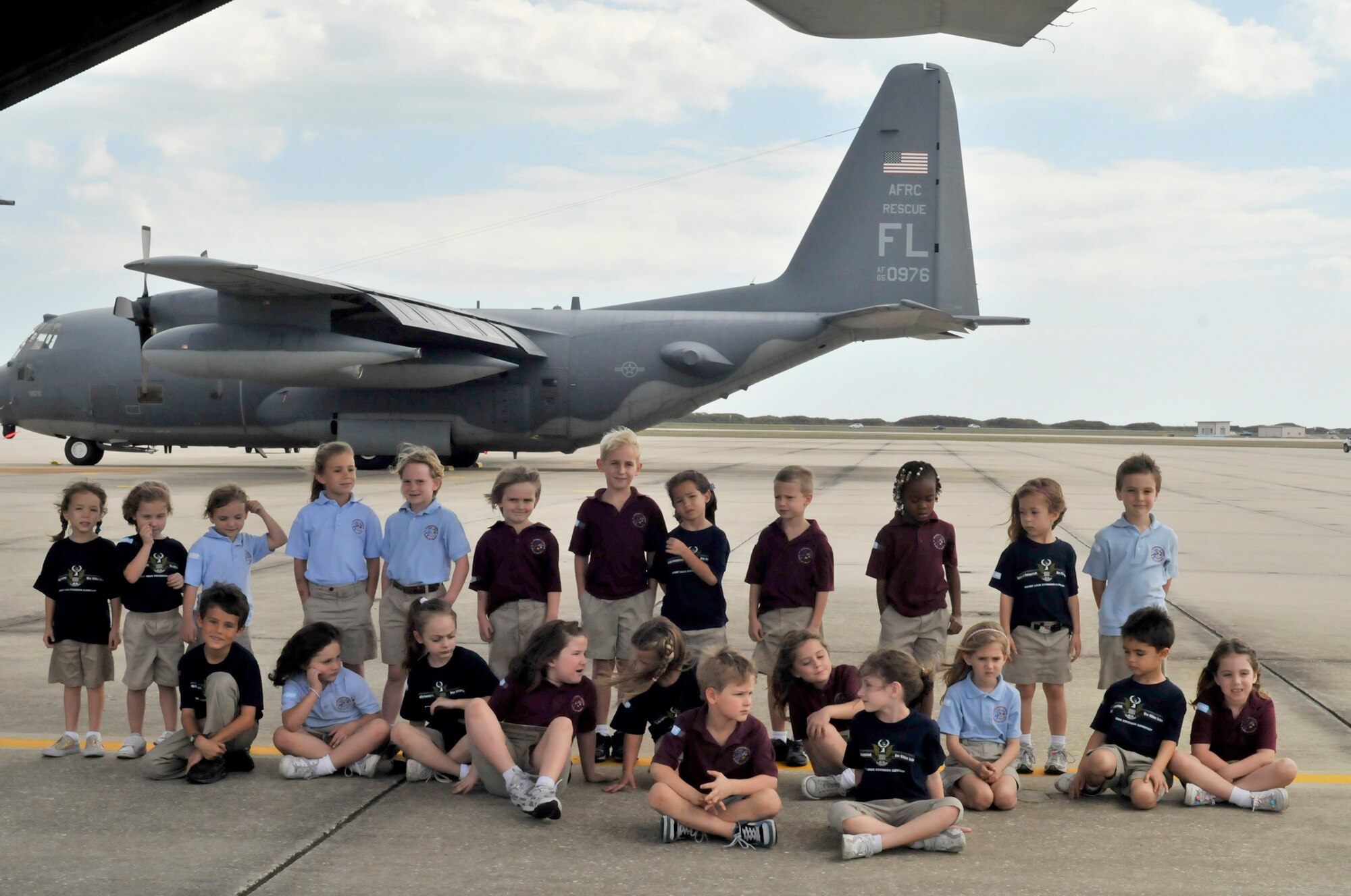 PATRICK AIR FORCE BASE, Fla. - Kindergarteners from a central Florida Elementary School pose for a photo on the flightline here Feb. 25 with an HC-130P/N King aircraft in the background. The day after space shuttle Discovery's last lift off, students spent several hours learning how Airmen of the 920th Rescue Wing are on alert to rescue astronauts during space shuttle lift offs. The 920th RQW is an Air Force Reserve combat-search-and-rescue unit here, but also serves as the primary rescue force for NASA astronauts during lift offs and returns. (U.S. Air Force photo/Capt. Cathleen Snow)