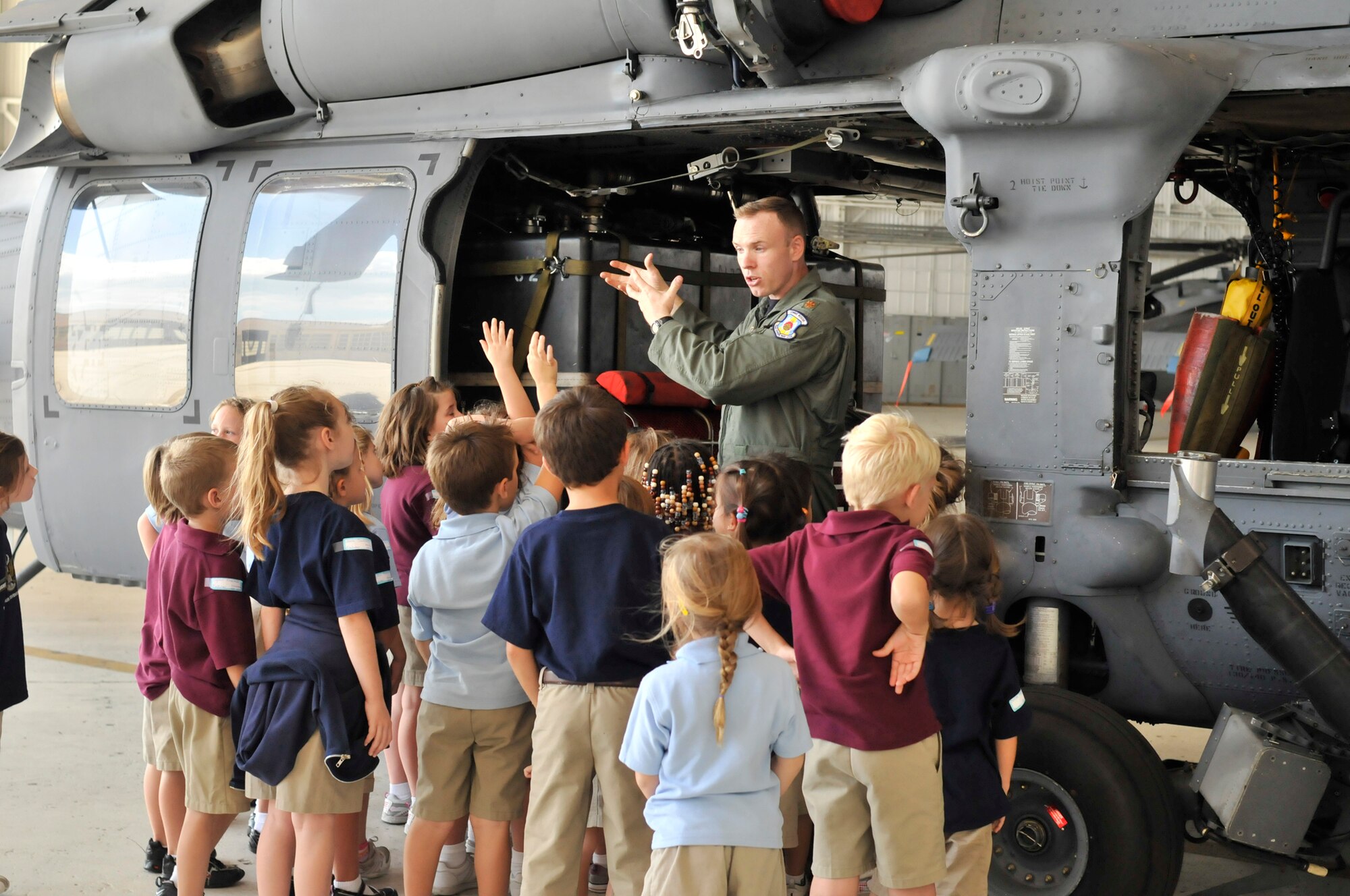 PATRICK AIR FORCE BASE, Fla. - Space Coast kindergarteners swarm around Maj. Dave Anderson, HH-60G Pave Hawk helicopter pilot, Feb. 25 as he shows the kids how the aircraft are used to rescue astronauts during space shuttle lift offs and landings if called upon. Airmen from the 920th Rescue Wing flew the aircraft in support of NASA space shuttle support operations the day prior, during Space Shuttle Discovery's last lift off. The reservists have been the primary force for responding to astronaut emergency's since the early 90s, during lift off, and until the shuttle returns safely to Earth with the astronauts on board. (U.S. Air Force photo/Capt. Cathleen Snow)