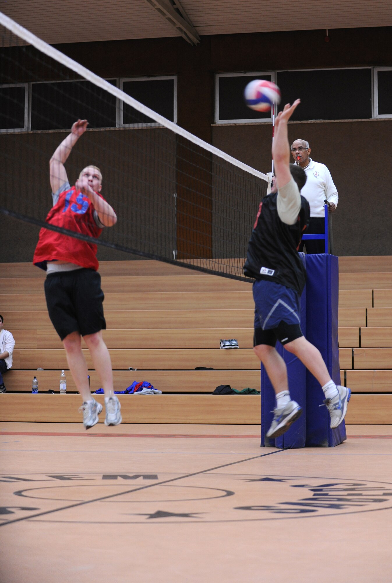 SPANGDAHLEM AIR BASE, Germany – Louis Shotto, left, 52nd Equipment Maintenance Squadron, spikes the ball over the net as Timothy Fordham, 52nd Comptroller Squadron, attempts to block the ball during an intramural volleyball match here Feb. 28. EMS defeated the 52nd Fighter Wing Staff Agencies team during the first match of the season. EMS took the first game 25-23 and the scond 25-14.  (U.S. Air Force photo/Senior Airman Nathanael Callon)