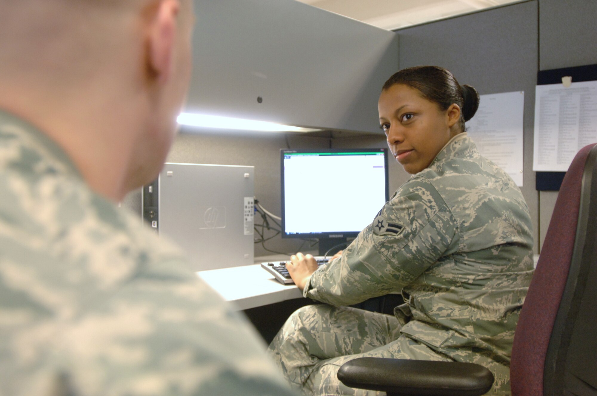 Airman 1st Class Erika Williams, 30th Intelligence Squadron imagery analyst and JBLE Tax Center volunteer, assists an Airman in filing Federal income taxes at the Joint Base Langley-Eustis Tax Center at Langley Air Force Base, Va., Feb. 24, 2011. The Tax Centers have processed more than 750 returns, which rendered more than $1 million in refunds, since opening Feb. 1. (U.S. Air Force photo by Airman 1st Class Jason J. Brown/Released)