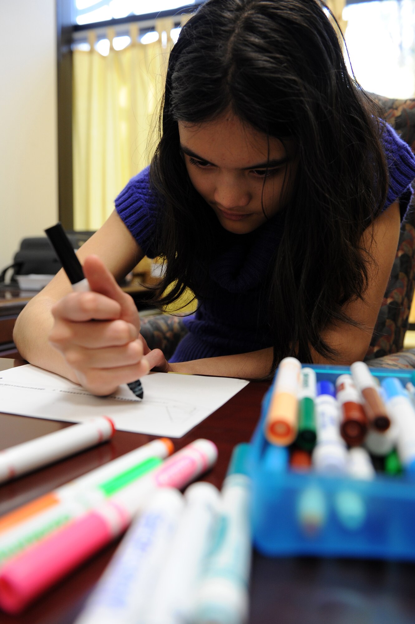 SEYMOUR JOHNSON AIR FORCE BASE, N.C. ? Melanie Green, 13, colors in the windows of a free-handed Delta plane sketch at the youth center here, Feb. 23, 2011. Melanie is Autistic so it is difficult for her to communicate her emotions. Drawing helps her parents understand how she feels about certain situations. She is the daughter of Master Sgt. Joshua Green, 4th Aircraft Maintenance Squadron. (U.S. Air Force photo/Staff Sgt. Courtney Richardson)(RELEASED)