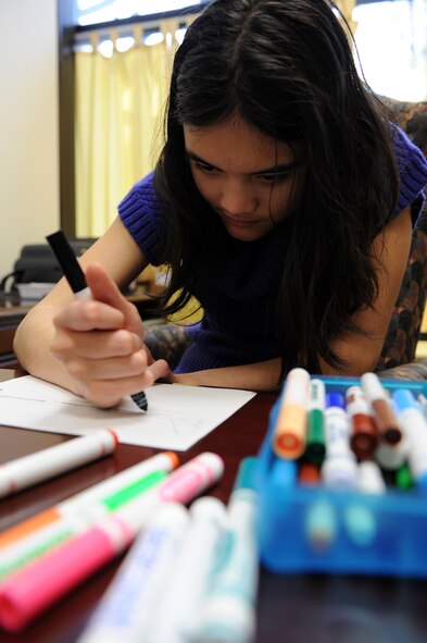 SEYMOUR JOHNSON AIR FORCE BASE, N.C. - Melanie Green, 13, colors in the windows of a free-handed Delta plane sketch at the youth center here, Feb. 23, 2011. Melanie is Autistic so it is difficult for her to communicate her emotions. Drawing helps her parents understand how she feels about certain situations. She is the daughter of Master Sgt. Joshua Green, 4th Aircraft Maintenance Squadron. (U.S. Air Force photo/Staff Sgt. Courtney Richardson)(RELEASED) 
