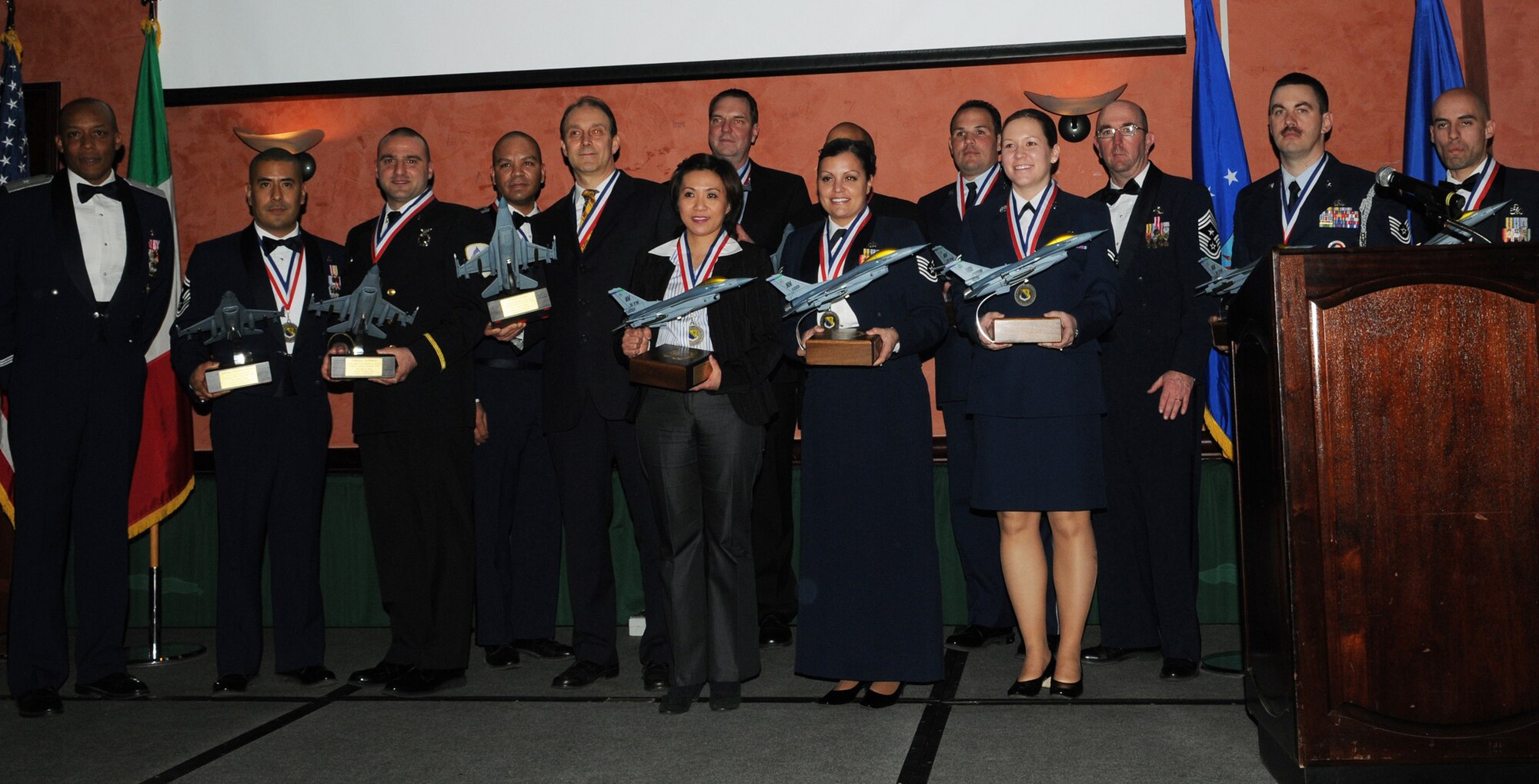 Aviano 2010 Annual Award winners gather for a group photo Feb. 25 at La Bella Vista Club. Brig. Gen. C.Q. Brown Jr. (left), 31st Fighter Wing commander, and Chief Master Sgt. Jeffrey Craver (third from right), 31st FW command chief, presided over the ceremony and presented awards to (from left to right) Senior Master Sgt. Emilio Avila, Fabrizio La Marca, Maj. Jose Lasso, Silvano Vivan, Brooks Garner, Jennifer McCray, Andre Bailey, Tech. Sgt. Samantha Whitfield, Senior Airman Juan Mercado-Guzman, Airman 1st Class Cassidy Roy, Tech. Sgt. David Frazier and Master Sgt. Mark Duarte. (U.S. Air Force photo/Airman Briana Jones)