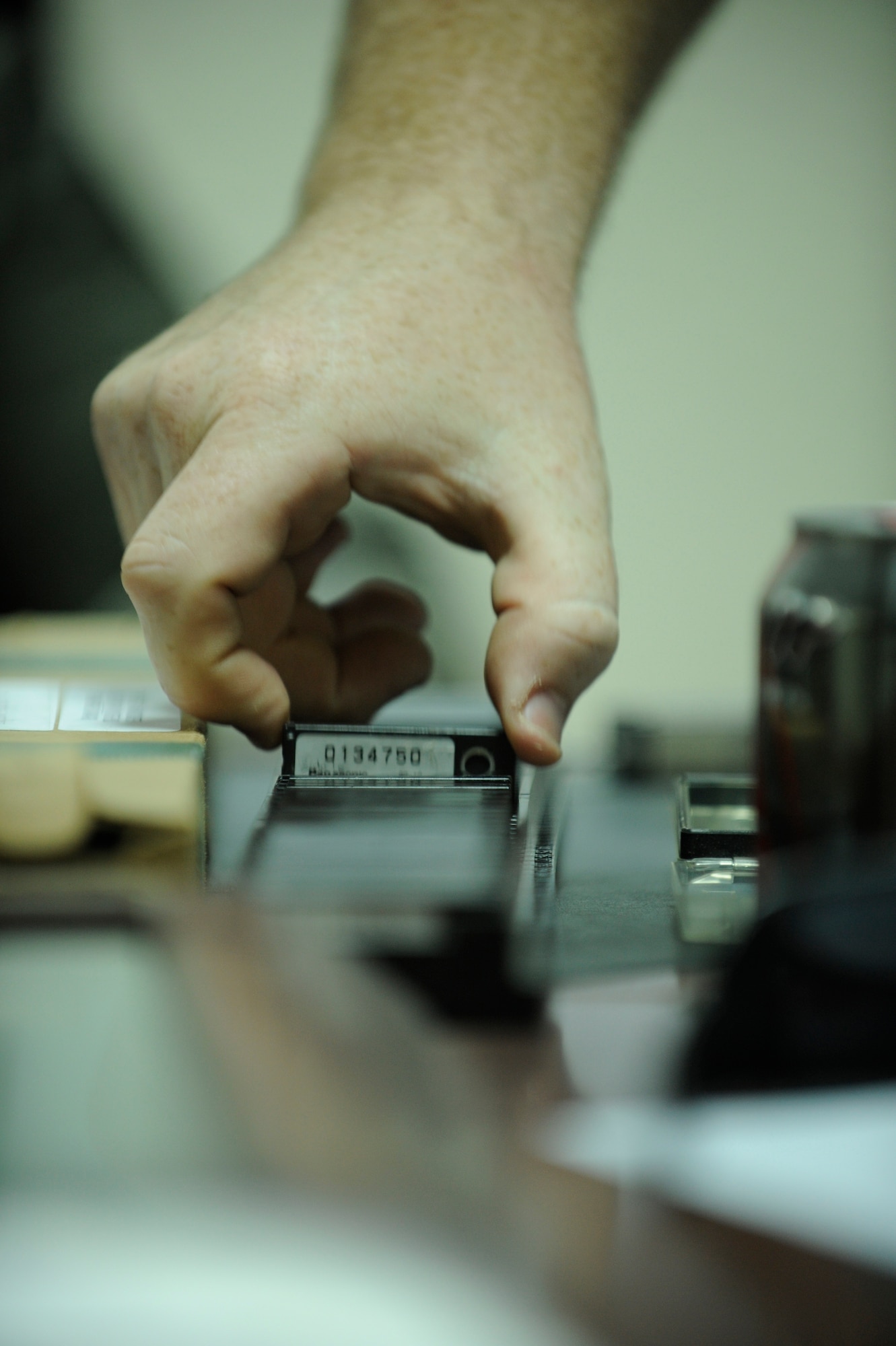 BAGHDAD -- Ryan May, in-country trainer for Science Applications International Corp., prepares dosimeters for a training session with members from the 447th Expeditionary Security Forces Squadron on the Vehicle and Cargo Inspection System Feb. 19. The VACIS is a recent addition to the Sather Air Base vehicle inspection arsenal and increases the capability to provide security to the base. (U.S. Air Force photo by Staff Sgt. Levi Riendeau)
