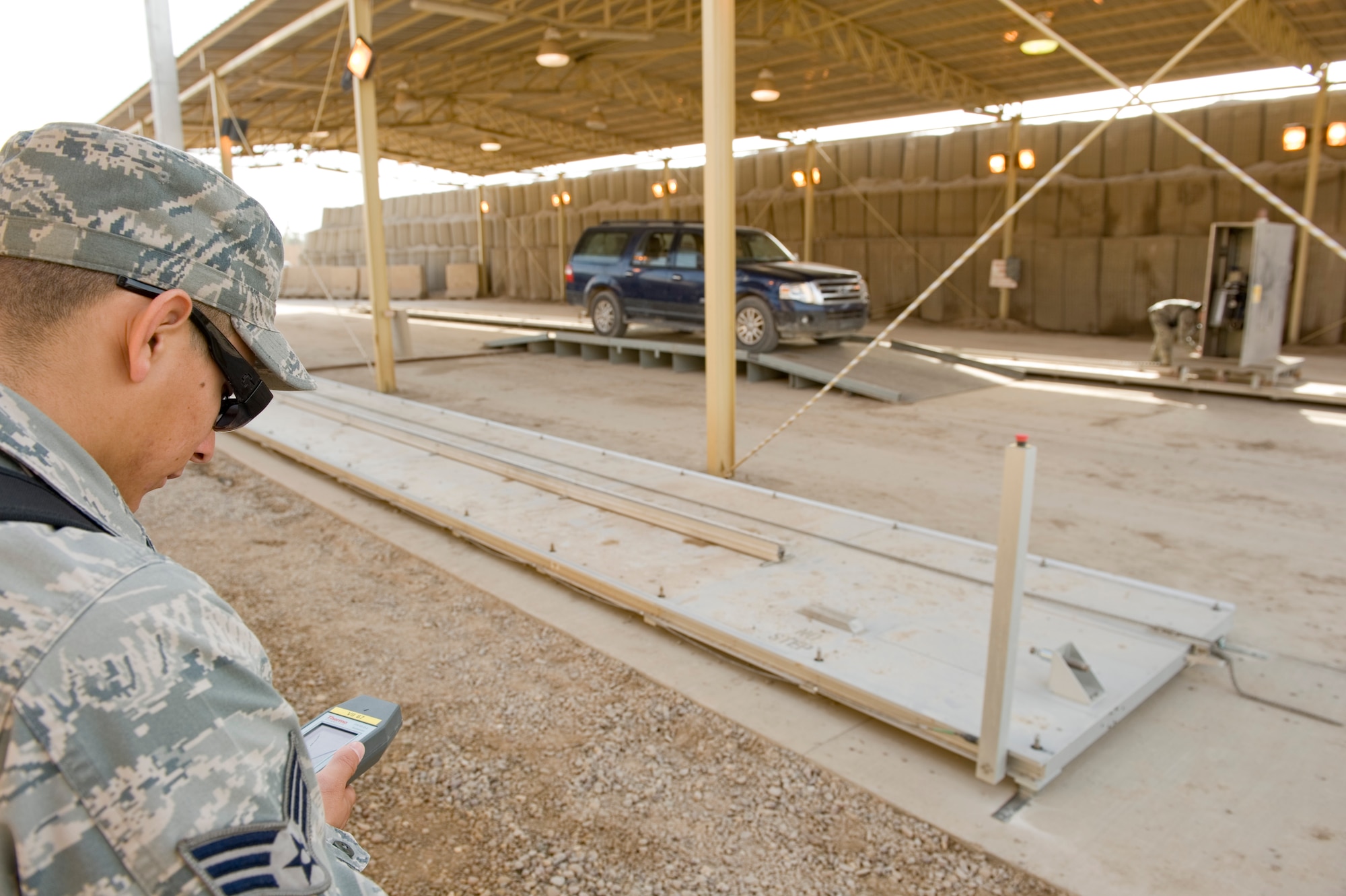 BAGHDAD -- Senior Airman David Leon, 447th Expeditionary Security Forces Squadron, checks radiation levels of the area around the relocatable Vehicle and Cargo Inspection System during training at Sather Air Base Feb. 22. The VACIS is a recent addition to the Sather Air Base vehicle inspection arsenal and increases the capability to provide security to the base. Airman Leon is deployed from the 355th Security Forces Squadron, Davis-Monthan Air Force Base, Ariz., and is a native of San Diego. (U.S. Air Force photo by Staff Sgt. Levi Riendeau)

