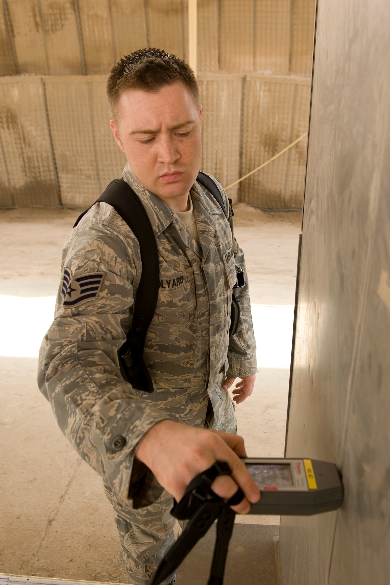 BAGHDAD -- Air Force Staff Sgt. Gerald Bolyard, 447th Expeditionary Security Forces Squadron member, checks radiation levels using the relocatable Vehicle and Cargo Inspection System during training Feb. 22. The VACIS is a recent addition to the Sather Air Base vehicle inspection arsenal and increases the capability to provide security to the base. Sergeant Bolyard is deployed from the 355th Security Forces Squadron, Davis-Monthan Air Force Base, Ariz., and is a native of Thompsonville, Ill.(U.S. Air Force photo by Staff Sgt. Levi Riendeau)
