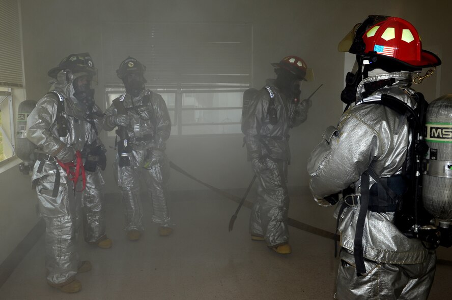 Firemen from the 18th Civil Engineer Squadron participate in a fire simulation during Beverly High 11-03, a local operational readiness exercise on Kadena Air Base, Japan, Feb. 28. The LORE tests the 18th Wing members in various situations to ensure they can effectively accomplish the mission in contingency situations. (U.S. Air Force photo/Junko Kinjo) 