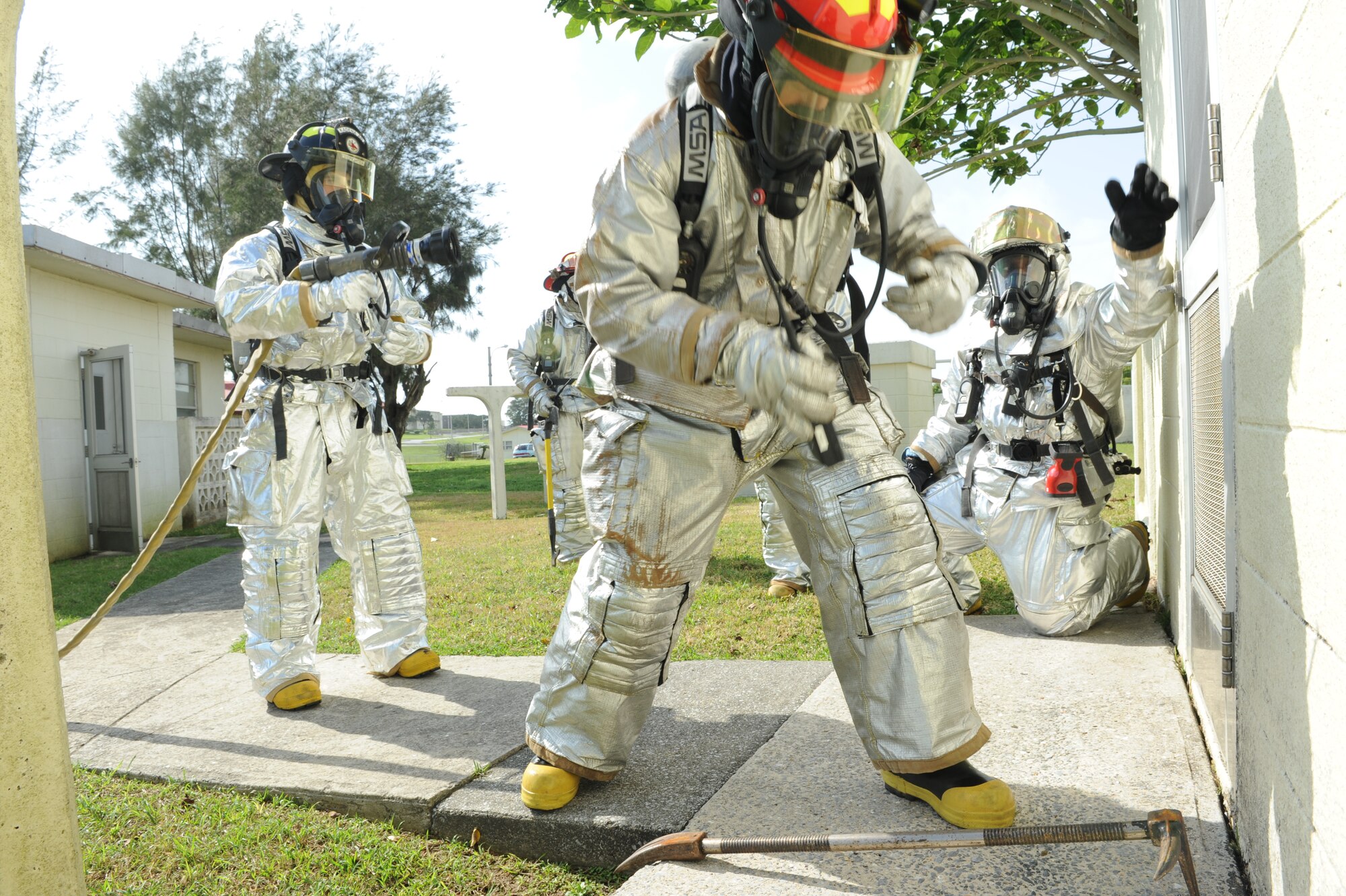 Firefighters from the 18th Civil Engineer Squadron prepare to enter a simulated burning building to extinguish the flame during Beverly High 11-03, a local operational readiness exercise on Kadena Air Base, Japan, Feb. 28. LOREs use various scenarios to train and prepare Airmen to respond to emergency situations. (U.S. Air Force photo/Junko Kinjo)