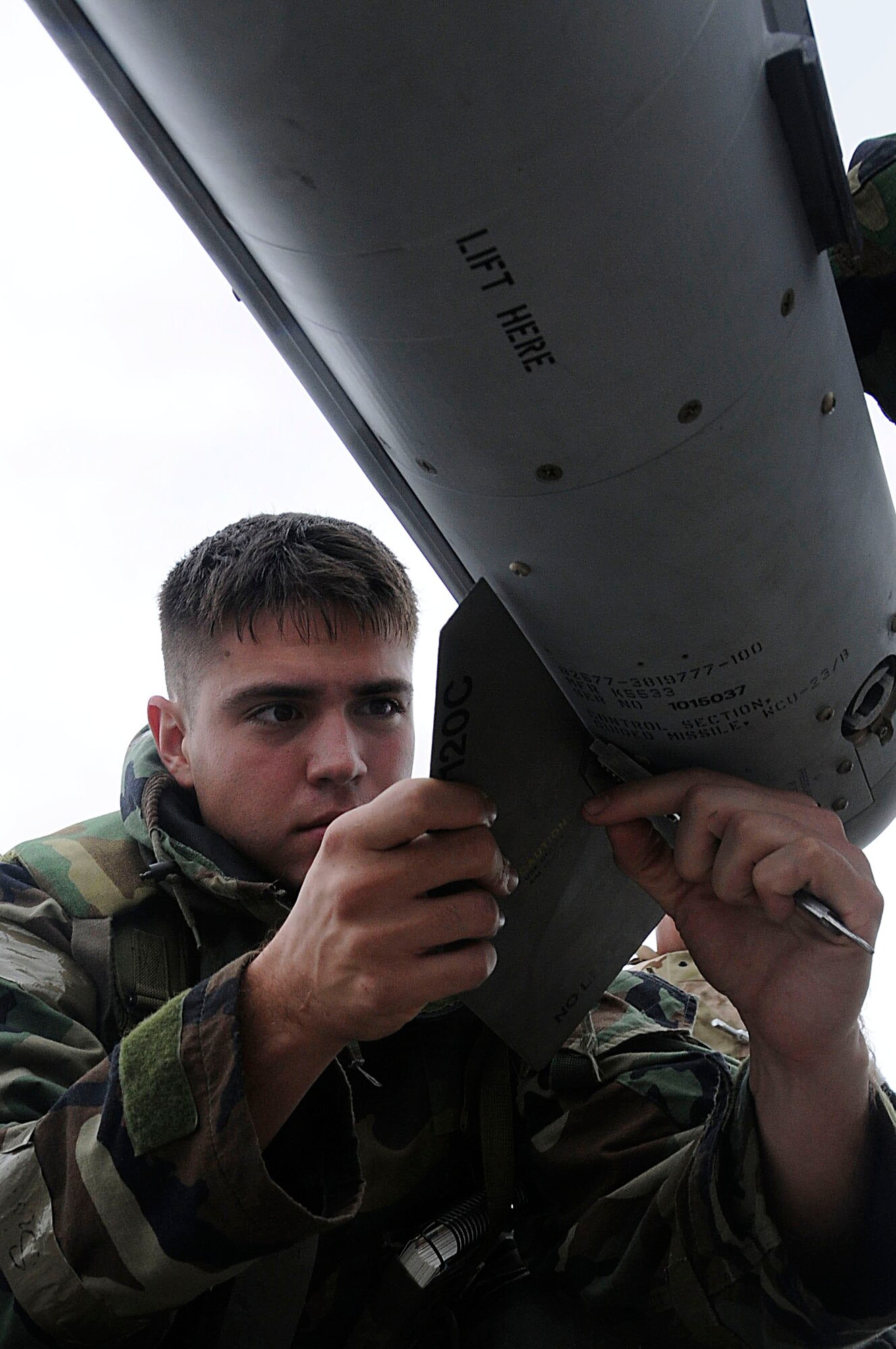 Senior Airman Andrew Gyke, 18th Aircraft Maintenance Squadron weapons load crew chief, removes a fin from the AIM-9X Missile during Beverly High 11-03, a local operational readiness exercise at Kadena Air Base, Japan, March 1. The exercise tested Team Kadena members' capabilities during a simulated contingency, therefore preparing them for future operations. (U.S. Air Force photo/ Staff Sgt. Darnell T. Cannady)