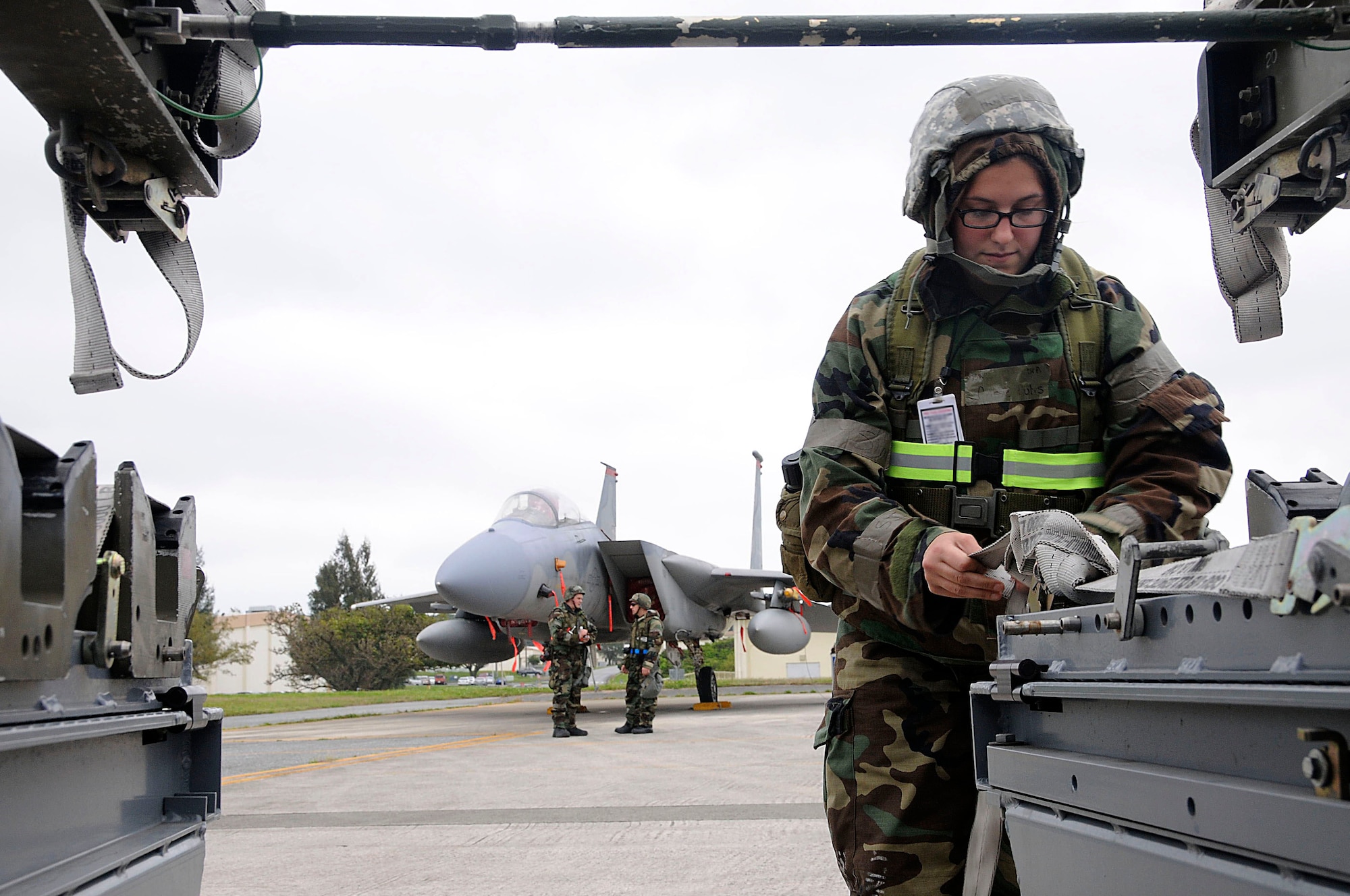 Senior Airman Cassie Hults, 18th Munitions Squadron precision-guided munitions crew chief, fastens the straps on the munitions trailer during Beverly High 11-03, a local operational readiness exercise at Kadena Air Base, Japan, March 1. Fastening the straps ensures that the missiles are secure and do not risk falling off when they are moved. (U.S. Air Force photo/ Staff Sgt. Darnell T. Cannady)