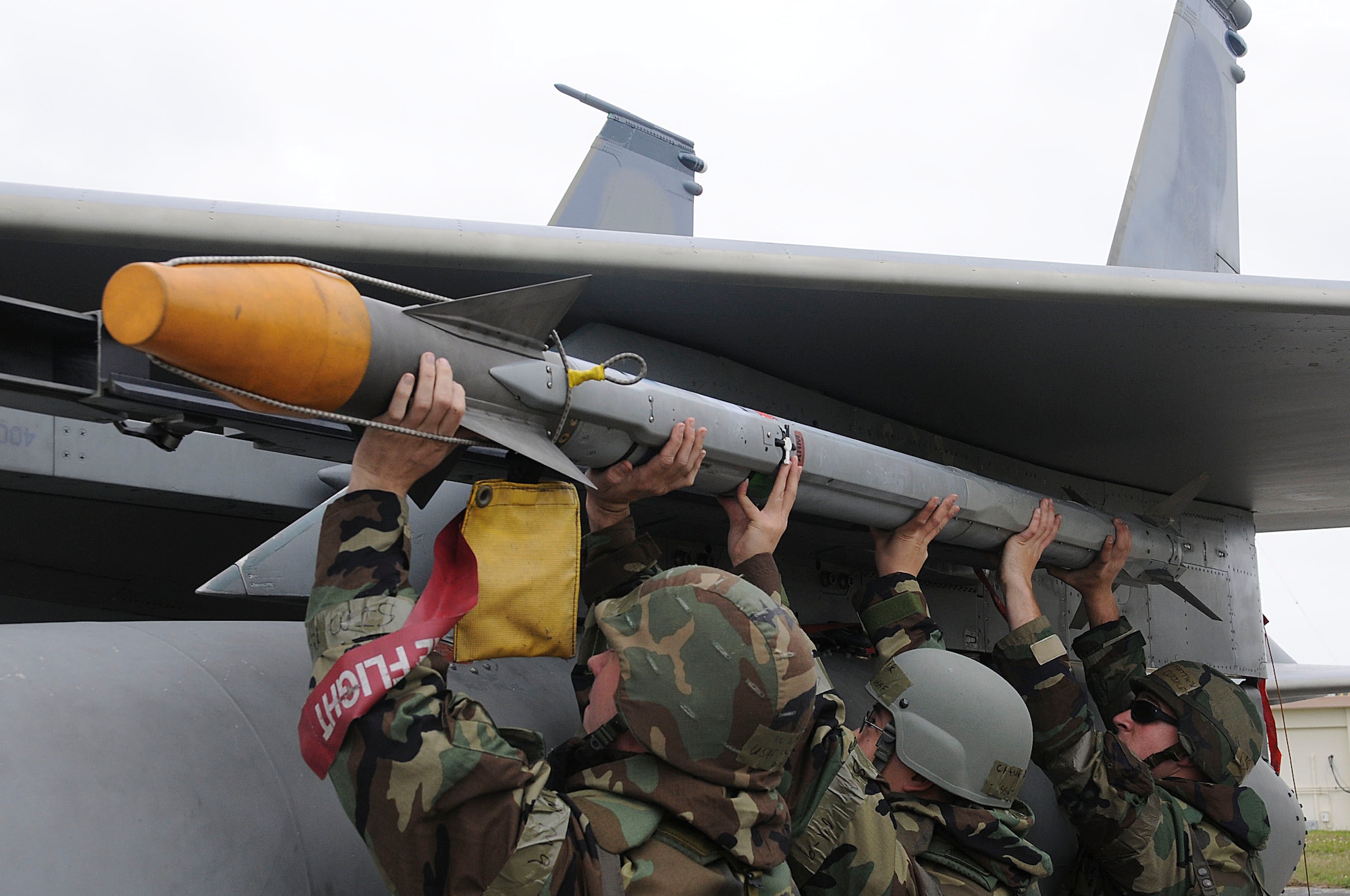 Members of the 44th Aircraft Maintenance Unit hold an AIM-9X missile for connection to an F-15 Eagle during Beverly High 11-03, a local operational readiness exercise at Kadena Air Base, Japan, March 1. The exercise tested Team Kadena's ability to operate and complete the mission during a multitude of contingency scenarios. (U.S. Air Force photo/ Staff Sgt. Darnell T. Cannady)