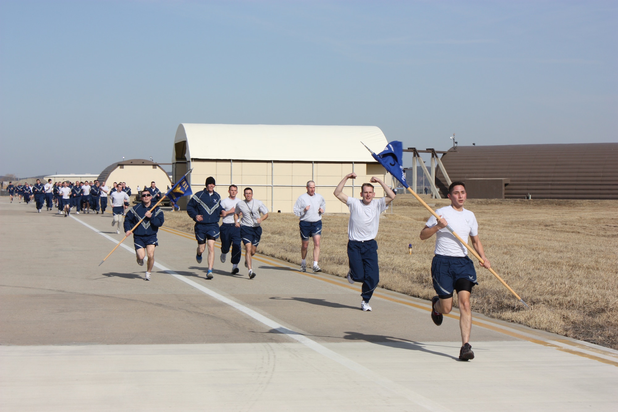 KUNSAN AIR BASE, Republic of Korea -- 8th Aircraft Maintenance Squadron Airmen run down the flight line here as their team-building exercise for Winter Wingman Day 2011 Feb. 25. A day celebrated around the Air Force, Wingman Day was meant to reinforce the wingman concept as the foundation to building resilient Airmen. (U.S. Air Force photo/Master Sgt. Junius Marshall III)