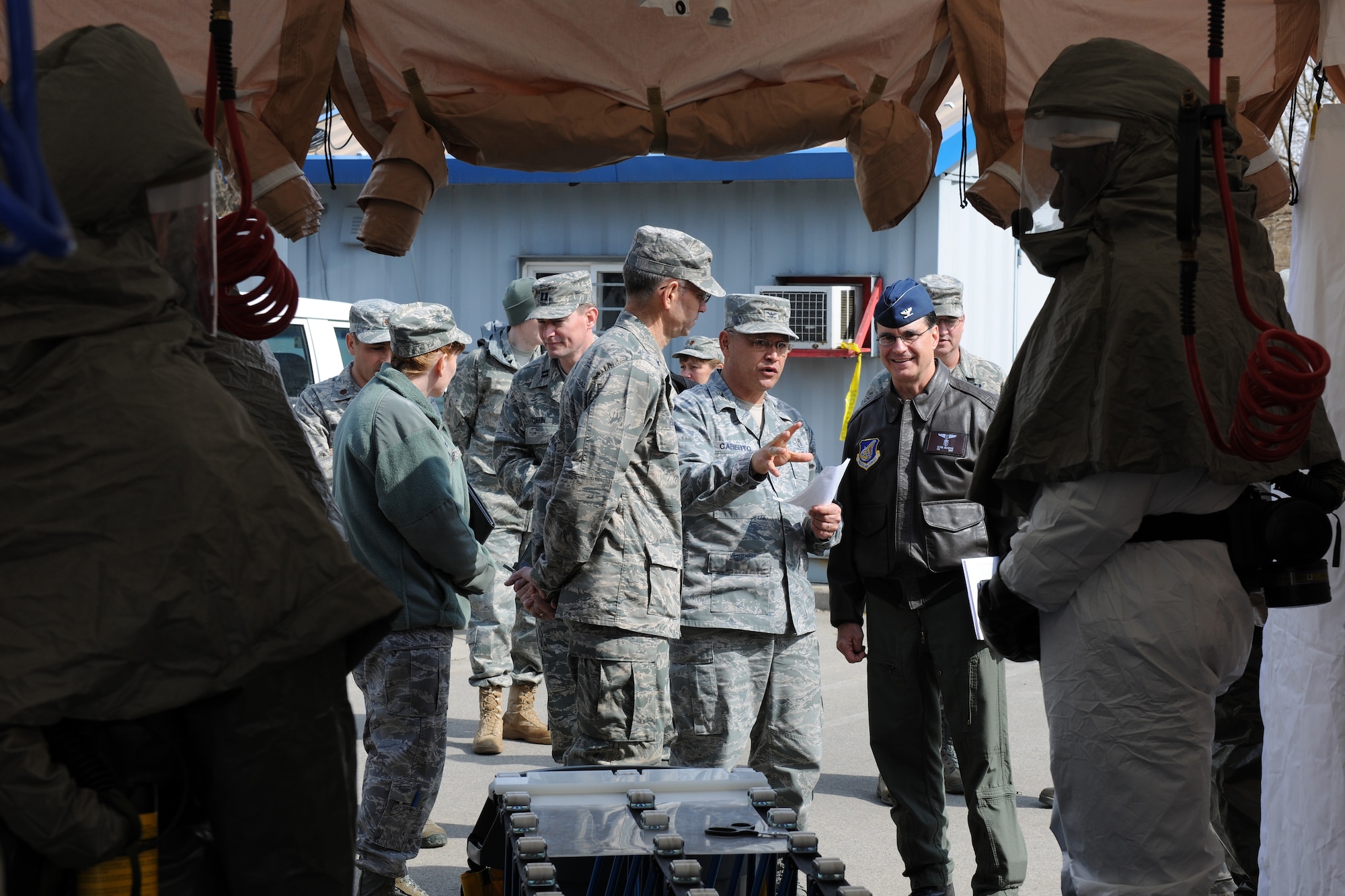 KUNSAN AIR BASE, Republic of Korea -- Brig. Gen. Mark Ediger, Air Force Operations Agency commander, and Col. Sean Murphy, Pacific Air Forces surgeon general, listen to a briefing by Col. Steven Caberto, 8th Medical Group commander, after watching an in-place patient decontamination demonstration while visiting the base here Feb. 25. An IPPD team is responsible for decontaminating personnel affected by a chemical, biological, radiological, nuclear and high-yield explosive weapons attack before they enter the clinic for further care. (U.S. Air Force photo/Tech. Sgt. Jonathan Pomeroy) 