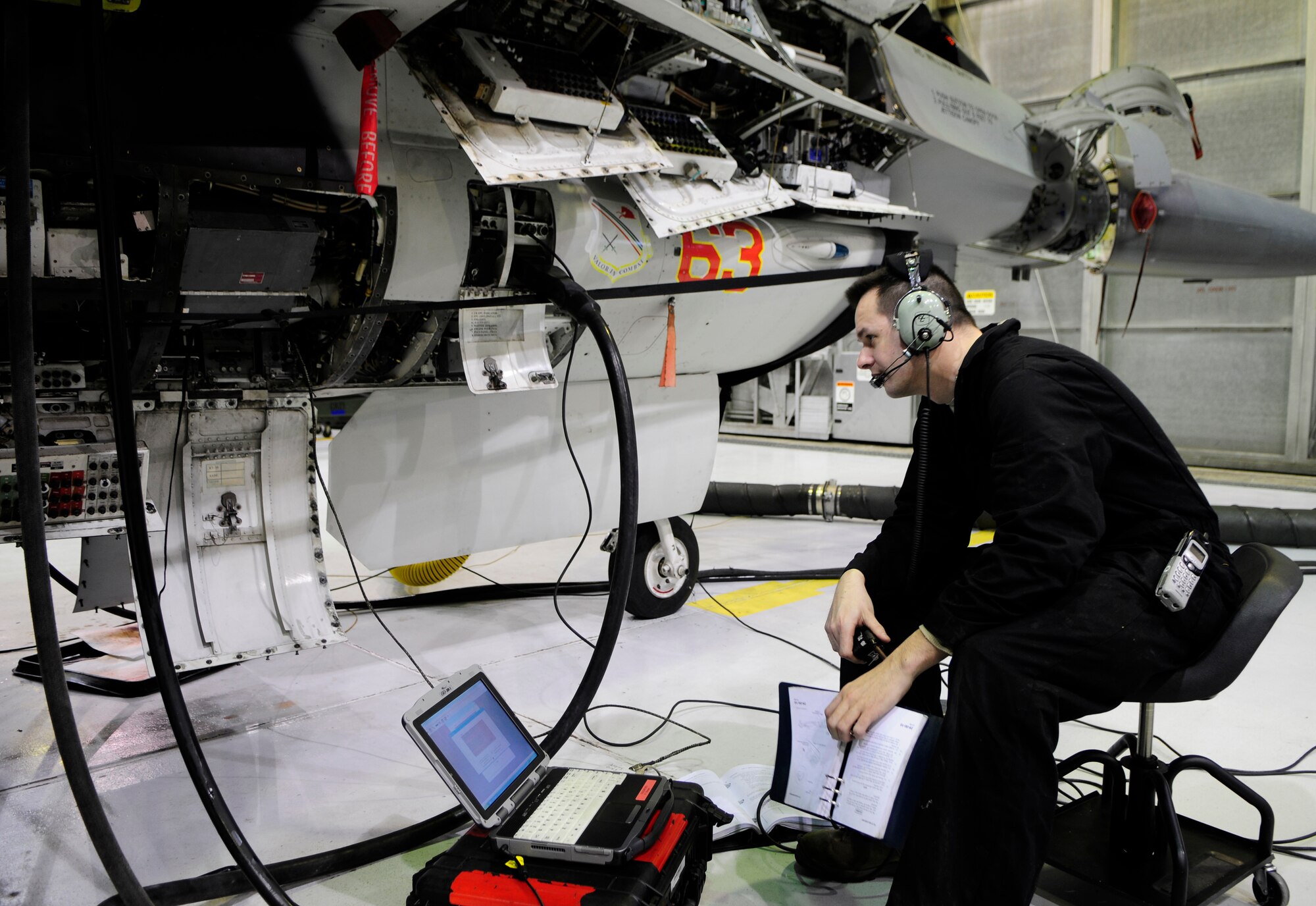 Tech. Sgt. Samuel Corbisez confirms system diagnostic checks on various aircraft components of an F-16 Fighting Falcon Feb. 16, 2011, Eielson Air Force Base, Alaska.  Inspection teams use work cards and computer based diagnostics to troubleshooot aircraft systems during phase inspections.  Sergeant Corbisez is assigned to the 354th  Maintenance Squadron as a phase dock chief.  (U.S. Photo by/Airman 1st Class Yash Rojas) 