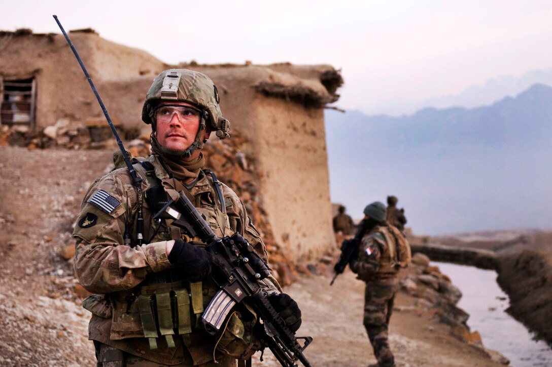 U.S. Army Sgt. Robert Streeter scans a nearby hilltop during a search of the Qual-e Jala village, Parwan province, Afghanistan, Feb. 21, 2011. Streeter is assigned to the 34th Infantry Division's 2nd Brigade Combat Team, 1st Squadron, 113th Cavalry Regiment, Task Force Redhorse.