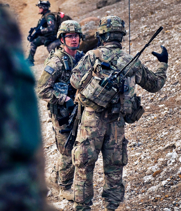 U.S. Army 2nd Lt. Andrew Smith, right, gives a report to U.S. Army Capt. Randall Stanford, left, during a search of the Qual-e Jala village, Afghanistan, Feb. 21, 2011. Smith and Stanford are assigned to the 34th Infantry Division's 2nd Brigade Combat Team, 1st Squadron, 113th Cavalry Regiment, Task Force Redhorse.